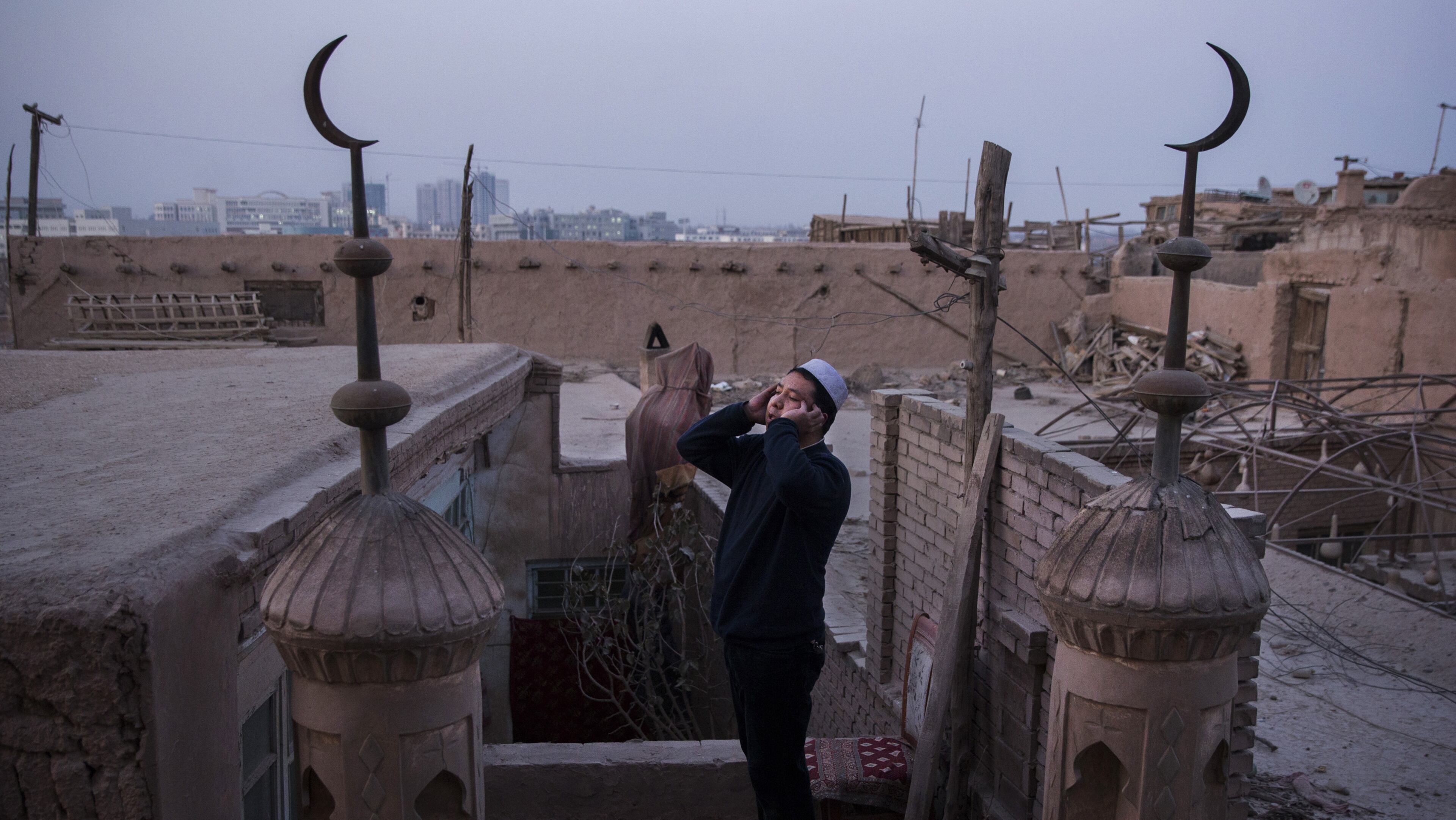 A muezzin shouts out the call to prayer from the roof of a mosque in Kashgar, in China’s far western province of Xinjiang. (Adam Dean/The New York Times)