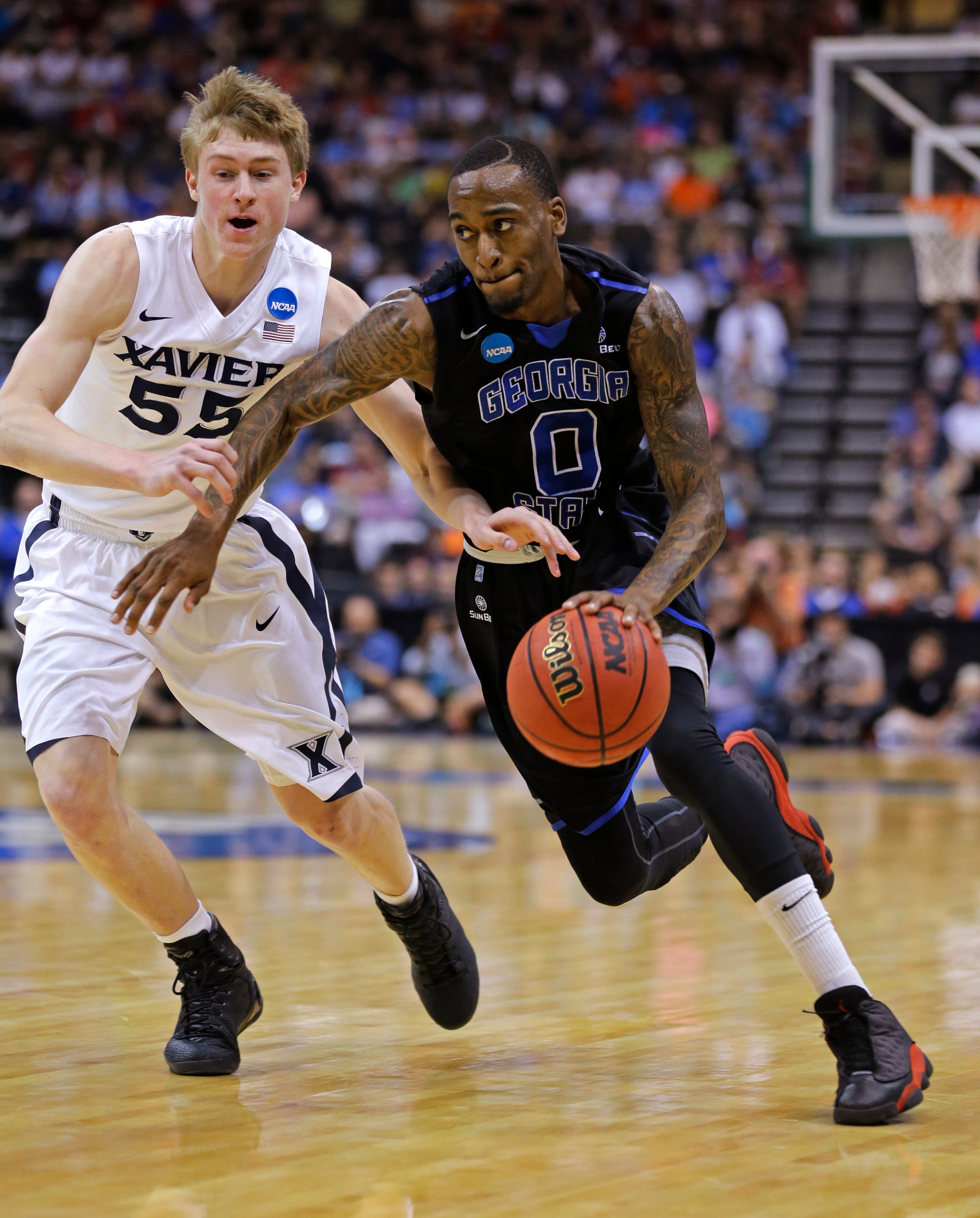 Georgia State guard Kevin Ware (0) drives past Xavier guard J.P. Macura (55) during the first half of an NCAA tournament third round college basketball game, Saturday, March 21, 2015, in Jacksonville, Fla. (AP Photo/Chris O'Meara)