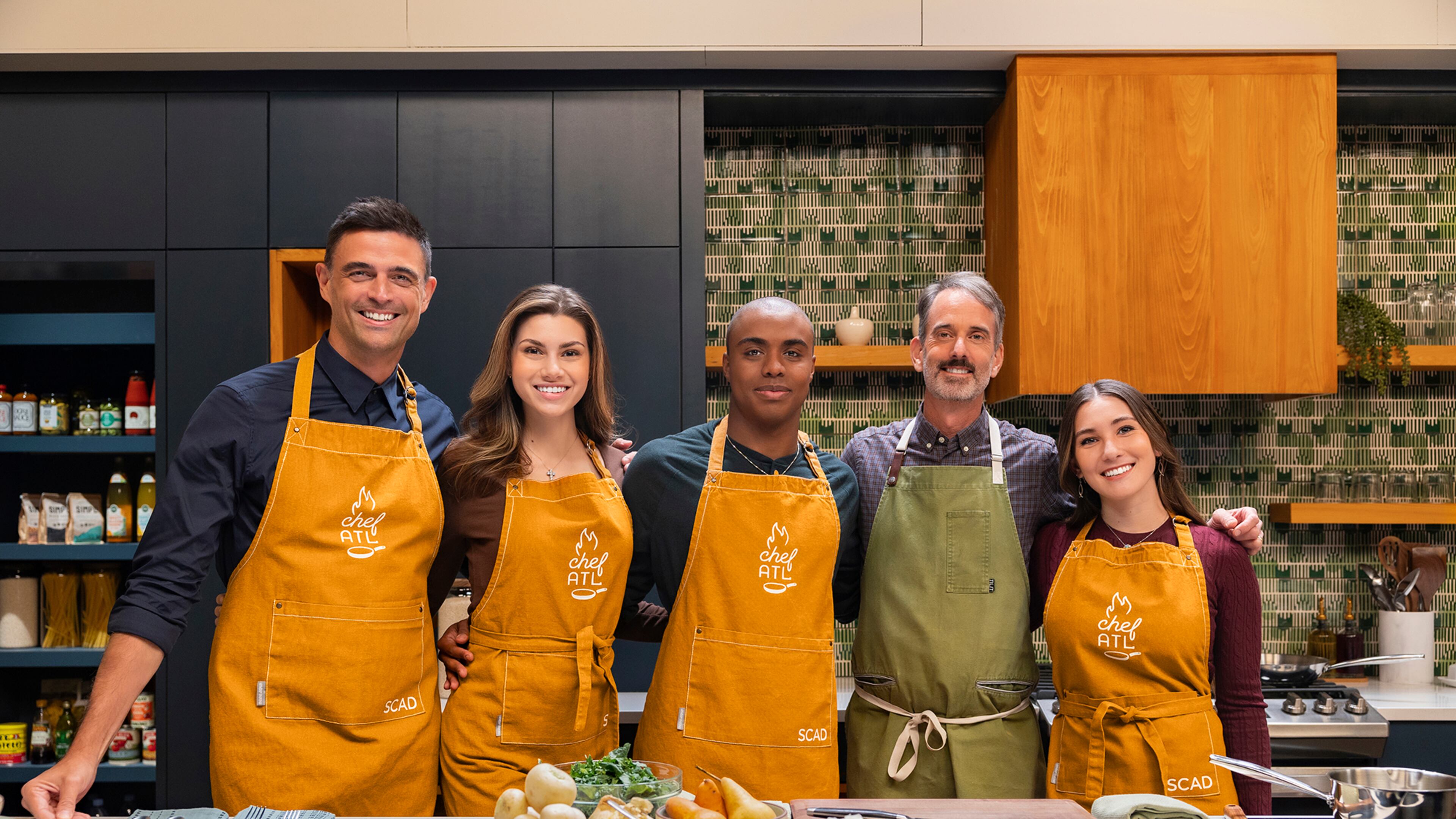 Miller Union chef Steven Satterfield (green apron), a leader in sustainability in Southern food, and TV personality and sustainability activist John Gidding pair up in the pilot episode of the SCAD produced docuseries chefATL.
(Courtesy of SCAD)