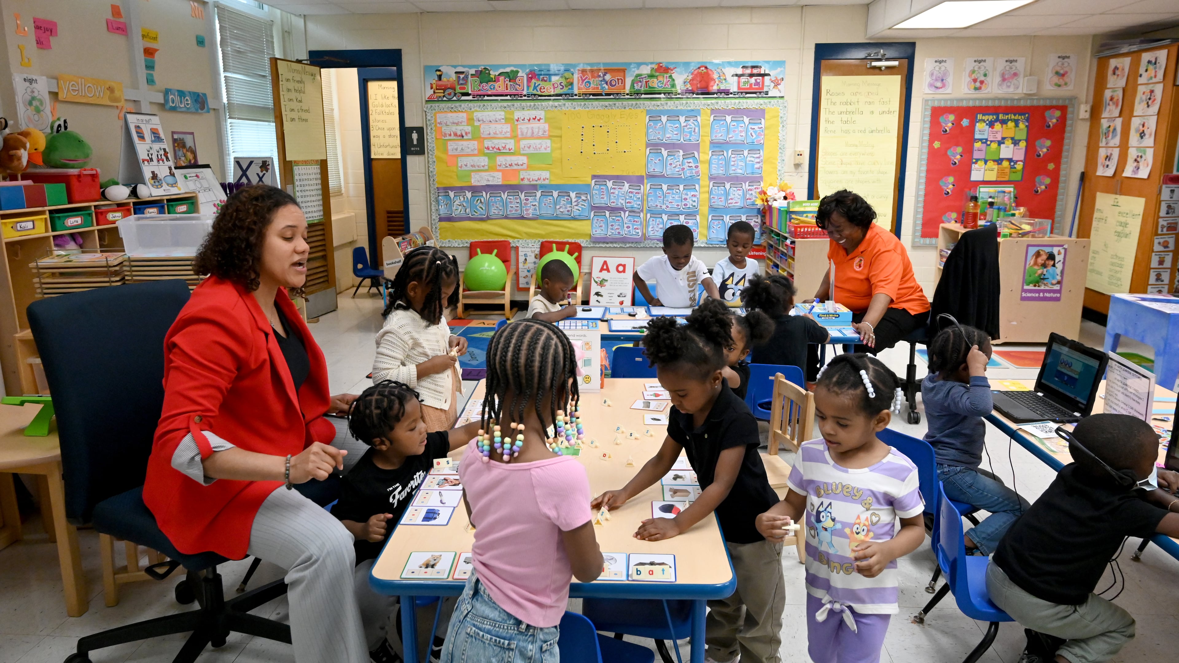 Pre-K teacher Ashley Wilson and Shirlene Hill (background), co-teacher, work with their students at DeKalb Early Learning Center, Wednesday, April 1, 2026, in Atlanta. (Hyosub Shin/AJC)