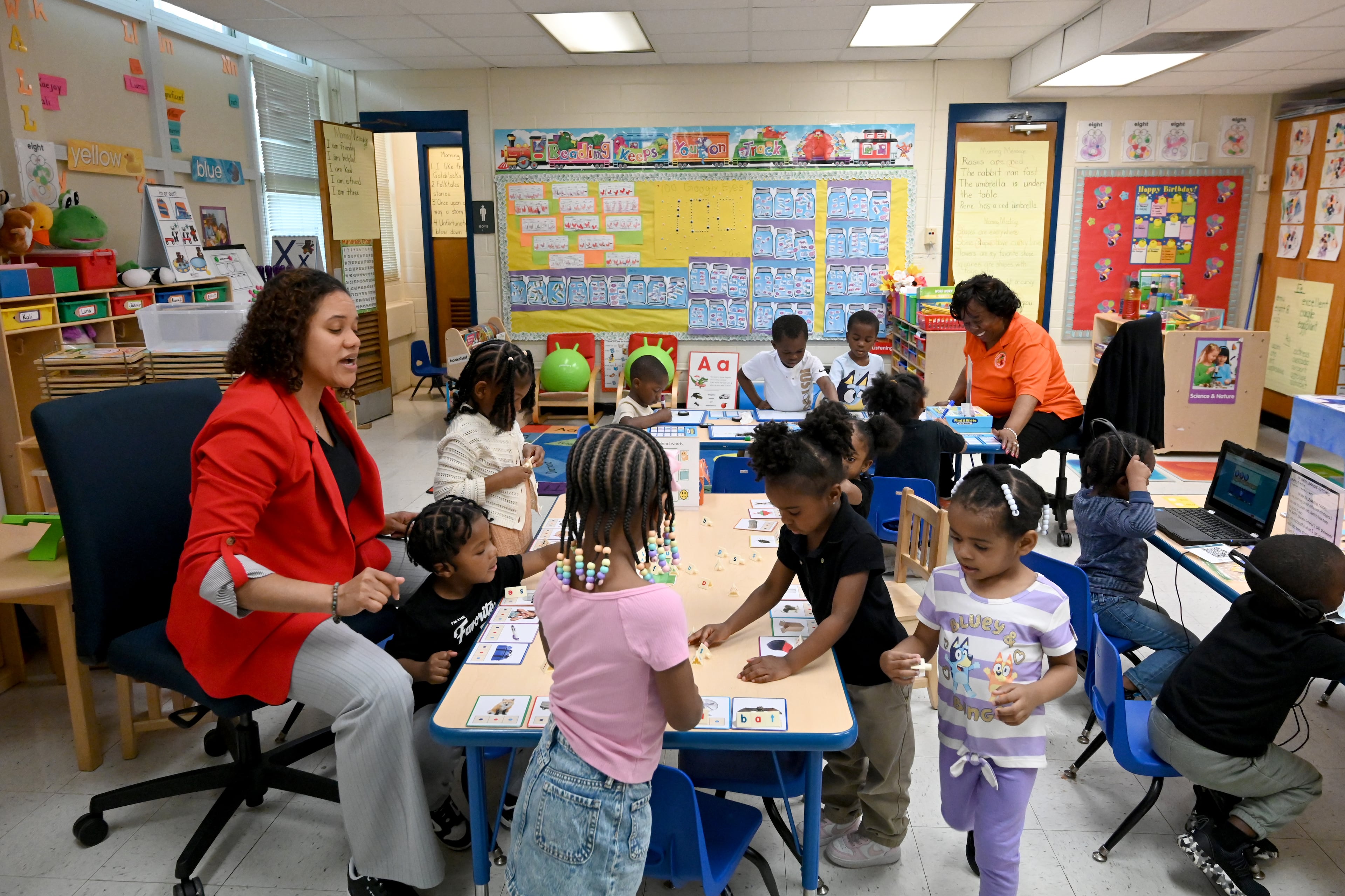 Pre-K teacher Ashley Wilson and Shirlene Hill (background), co-teacher, work with their students at DeKalb Early Learning Center, Wednesday, April 1, 2026, in Atlanta. (Hyosub Shin/AJC)