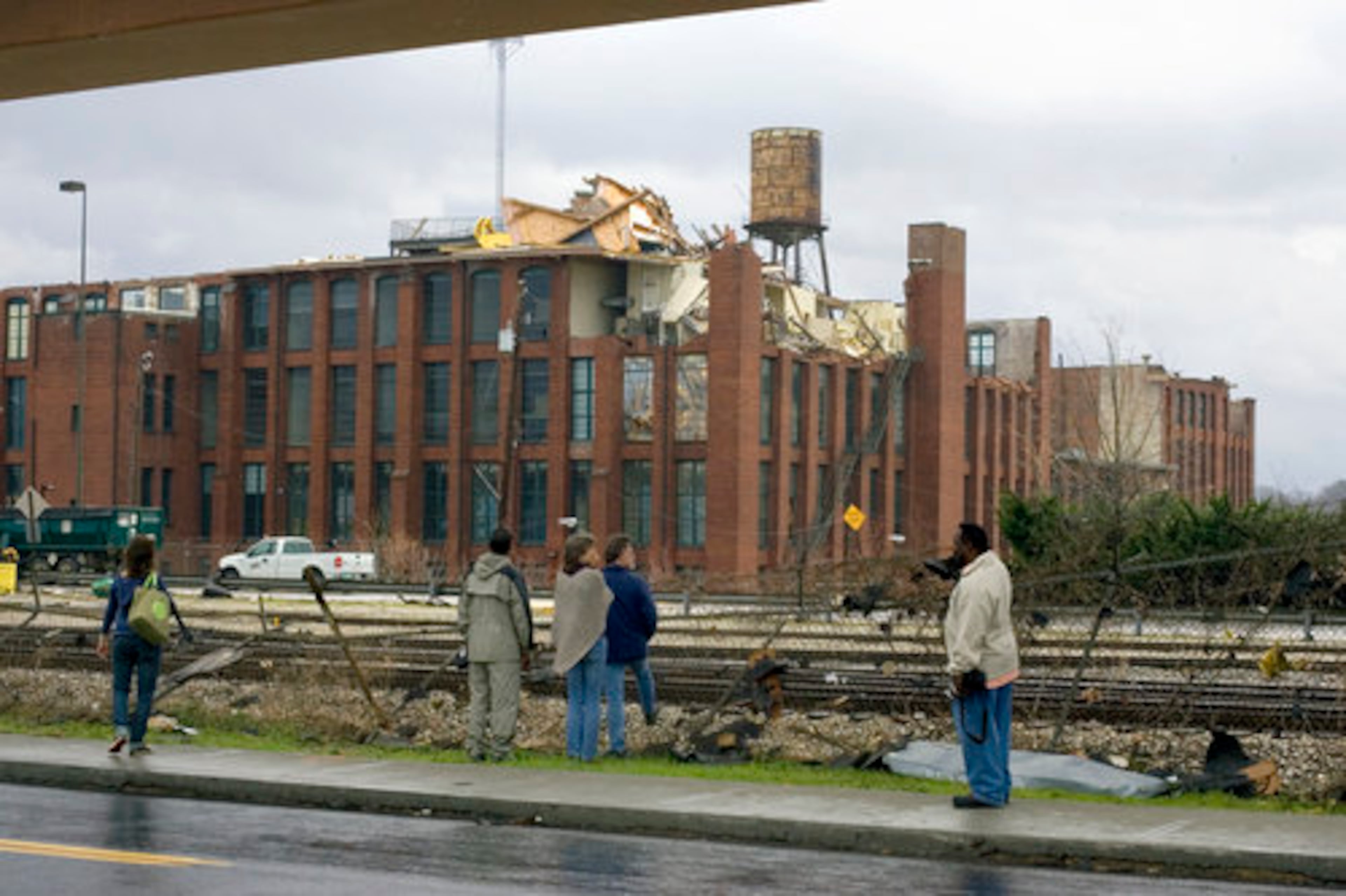 Saturday: People survey damage to the Fulton Cotton Mill lofts from DeKalb Avenue in Atlanta.