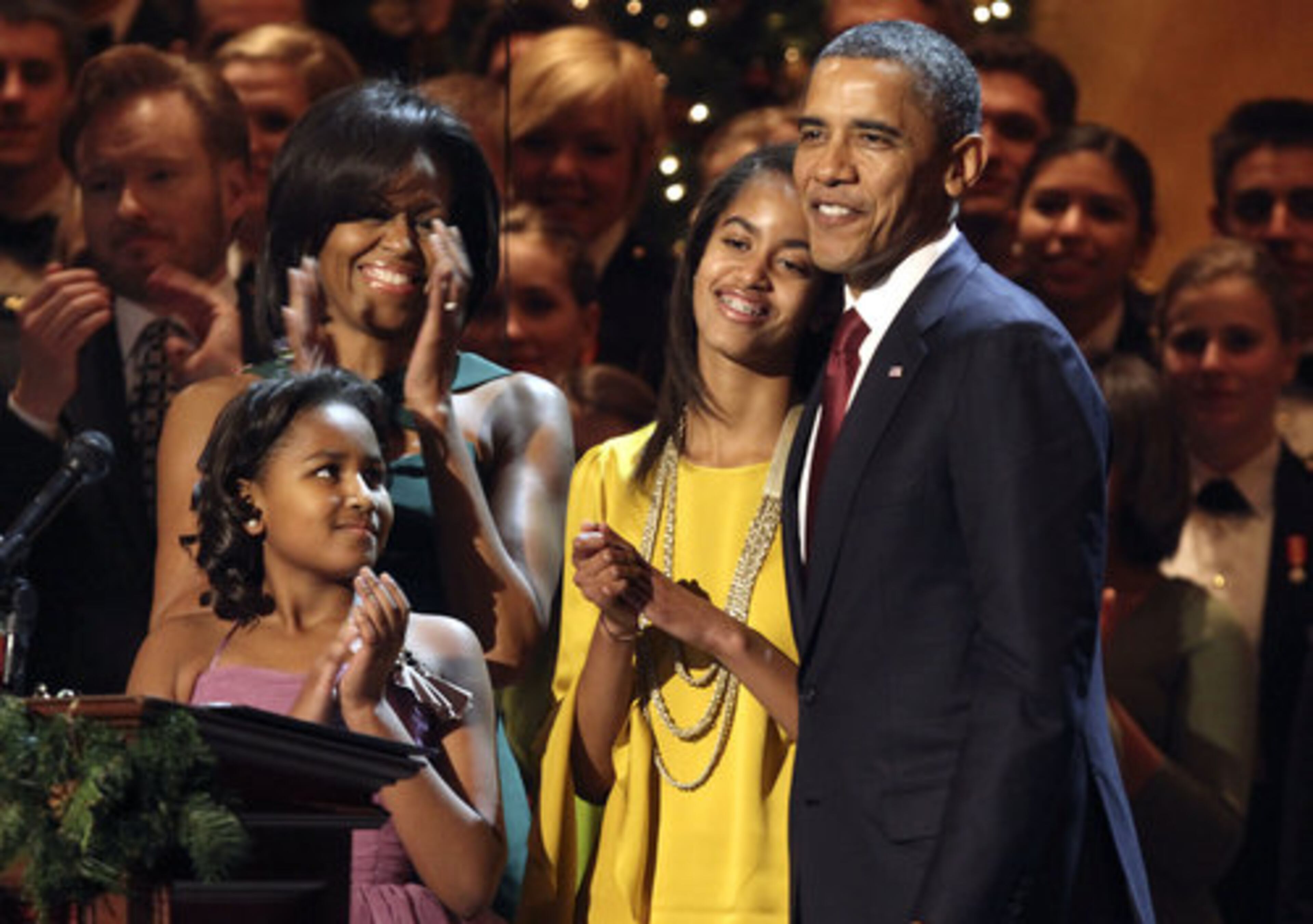 Sasha Obama, left, first lady Michelle Obama, Malia Obama, and President Barack Obama, are seen on stage at the annual Christmas in Washington taping at the National Building Museum in Washington, Sunday, Dec. 11, 2011.