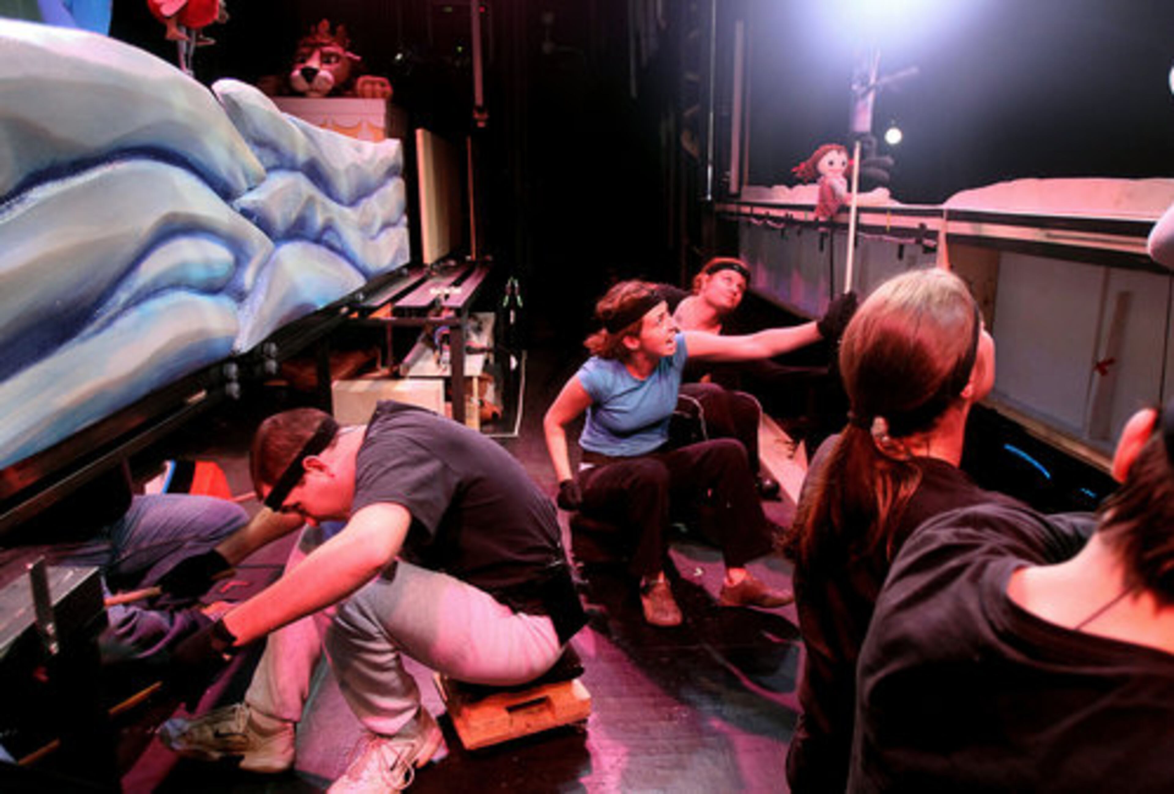 Tim Sweeney rolls to another set as Allison Murphy (in blue) & Amy Strictlands' puppets interact during rehearsals for the Center for Puppetry Arts' debut of their new production of "Rudolph the Red-nosed Reindeer." AJC file 2010
