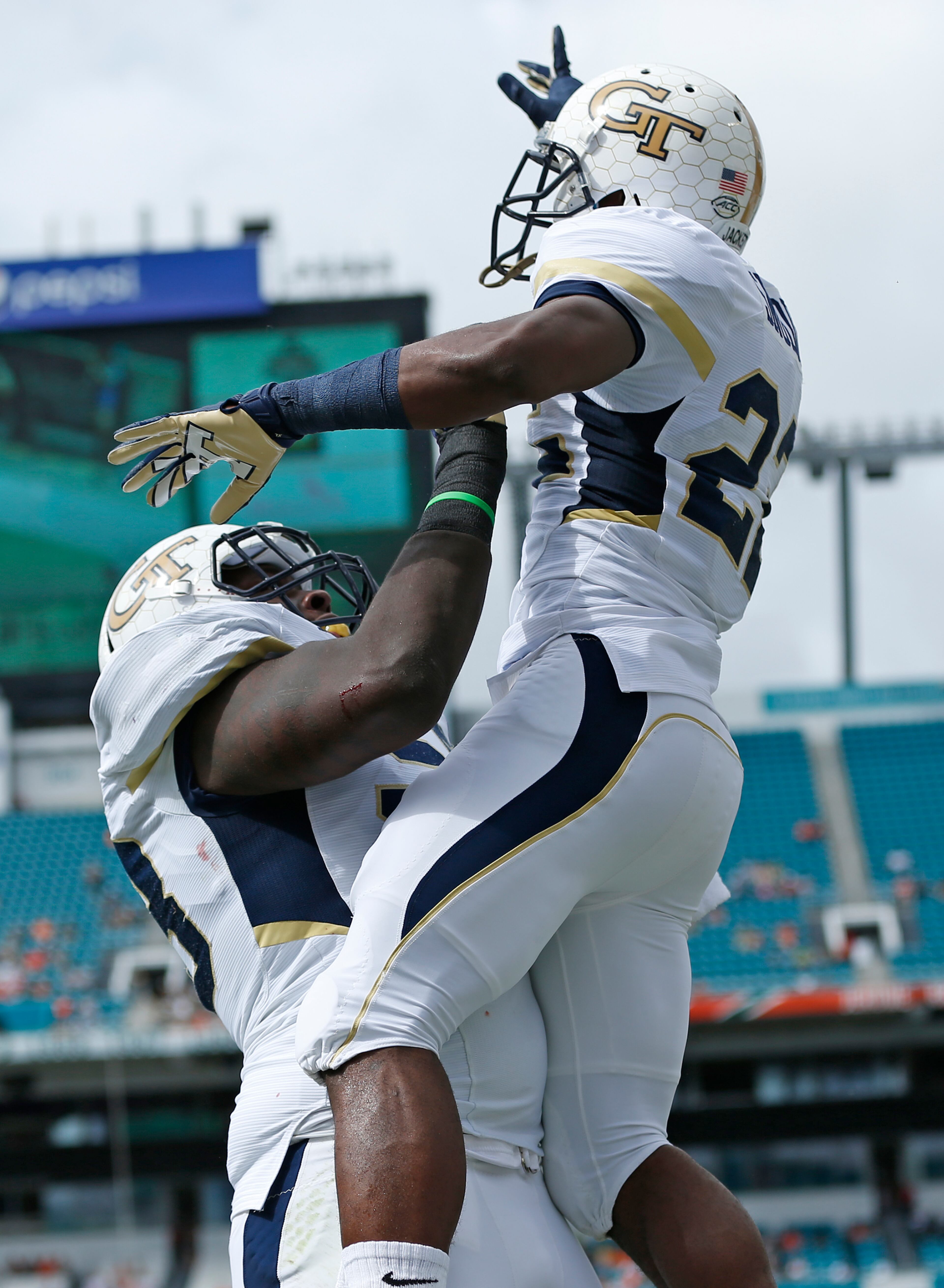 MIAMI GARDENS, FL - NOVEMBER 21: Broderick Snoddy #22 is raised in the air by Trey Braun #78 of the Georgia Tech Yellow Jackets after he scored a first quarter touchdown against the Miami Hurricanes on November 21, 2015 at Sun Life Stadium in Miami Gardens, Florida.(Photo by Joel Auerbach/Getty Images)