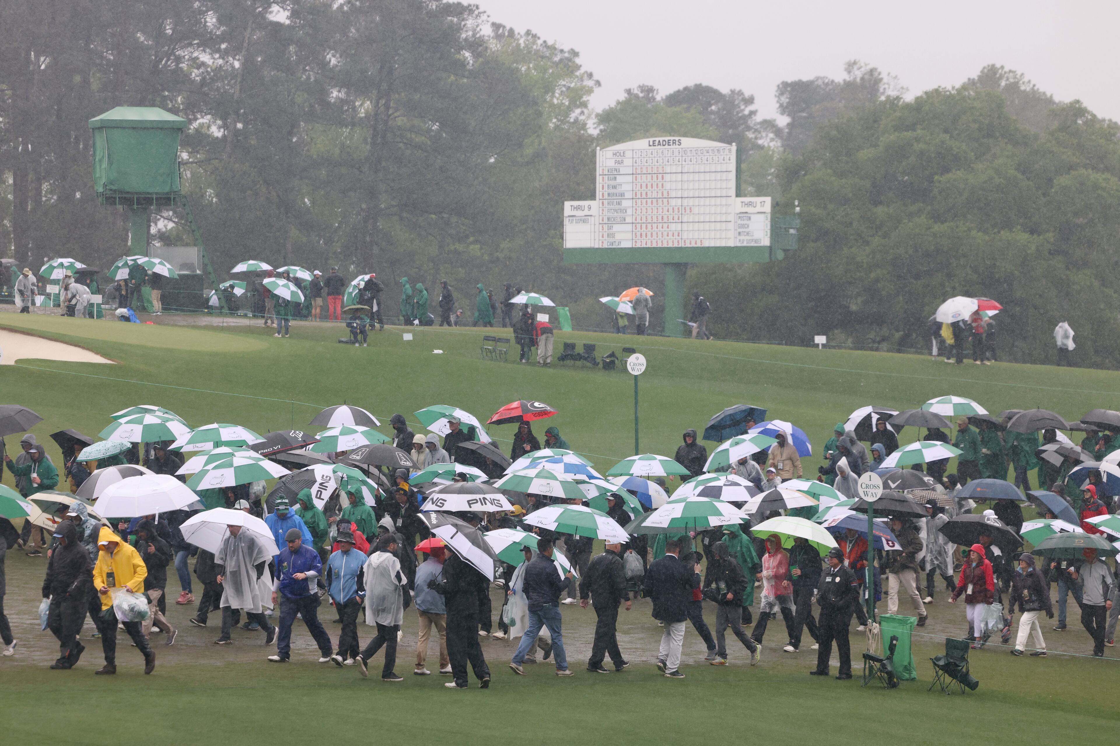 Patrons leave the course following suspension of play during third round of the 2023 Masters Tournament at Augusta National Golf Club, Saturday, April 8, 2023, in Augusta, Ga. (Jason Getz / Jason.Getz@ajc.com)