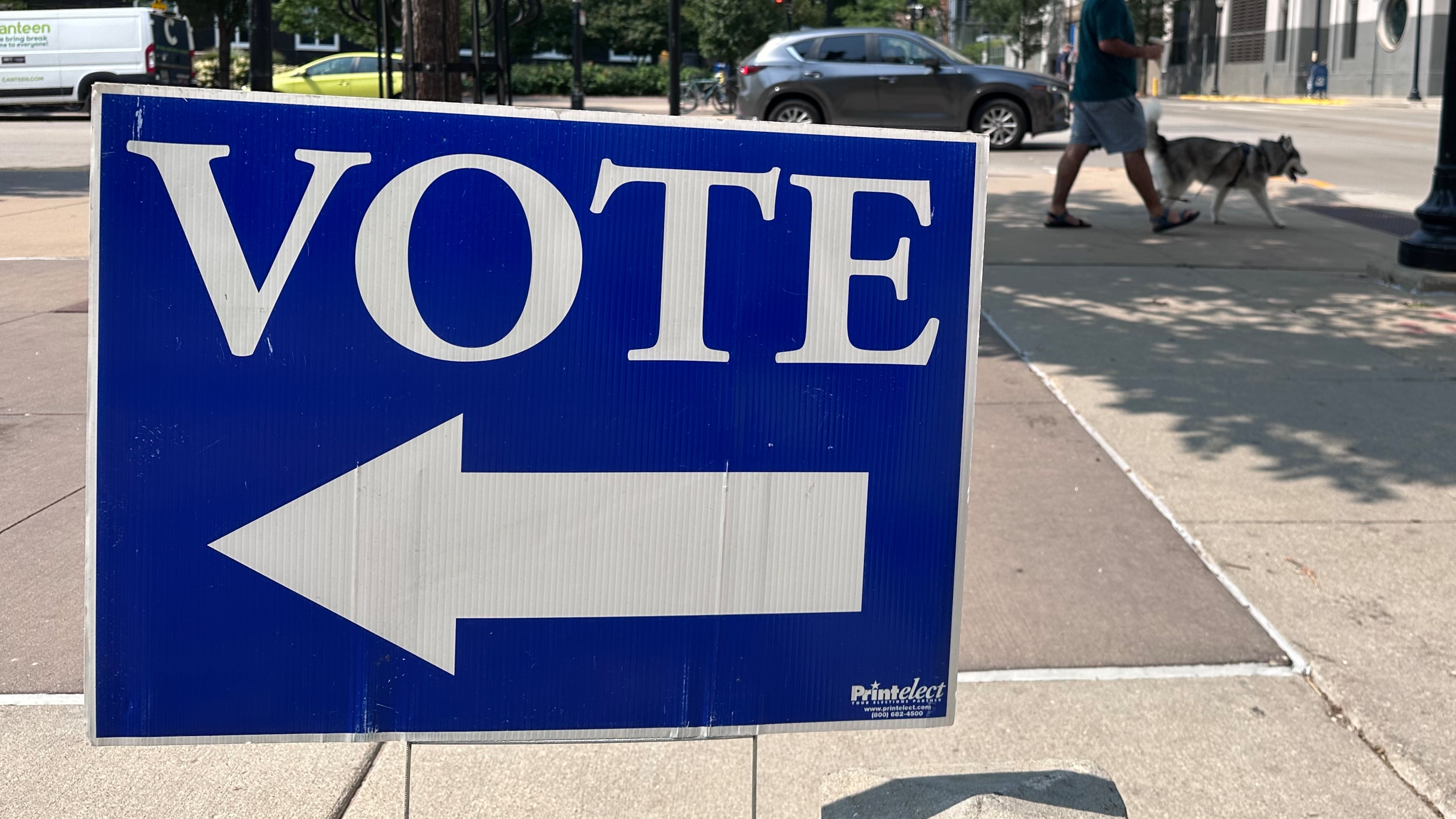 A person walks past a sign for a polling place on the first day of in-person absentee voting for Wisconsin's chaotic Democratic primary for governor Tuesday, July 28, 2026, in Madison, Wis. (AP Photo/Scott Bauer)