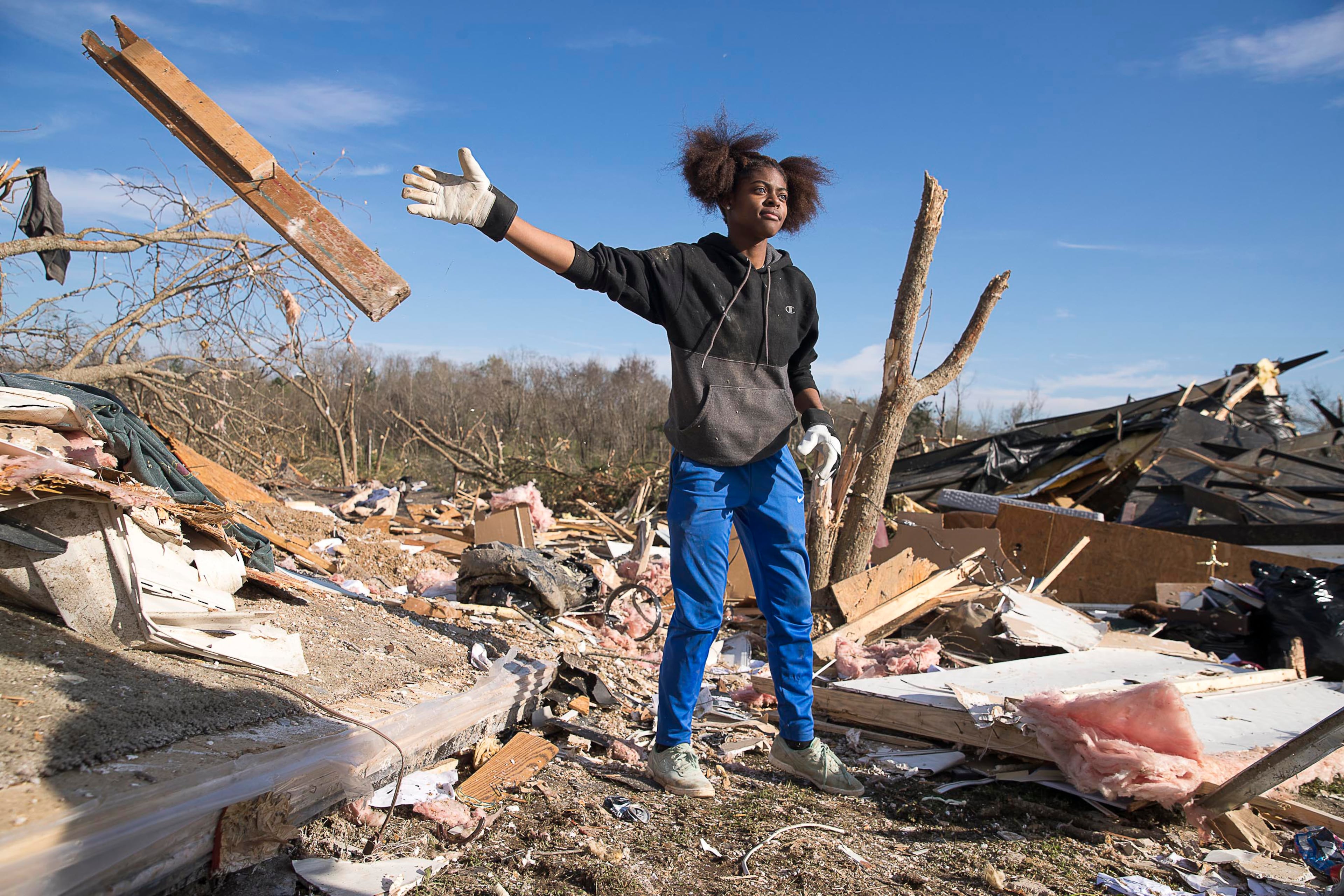 Asiah Bledsoe clears through debris as she looks for a photo of a family member at her grandfather's wrecked home in Talbotton, Monday, March 4, 2019. Keith Stellman, head forecaster for the National Weather Service, said during the presser that the path of destruction in the town looked to be caused by an EF2 tornado, although that wasn't confirmed during the governor's tour. (ALYSSA POINTER/ALYSSA.POINTER@AJC.COM)