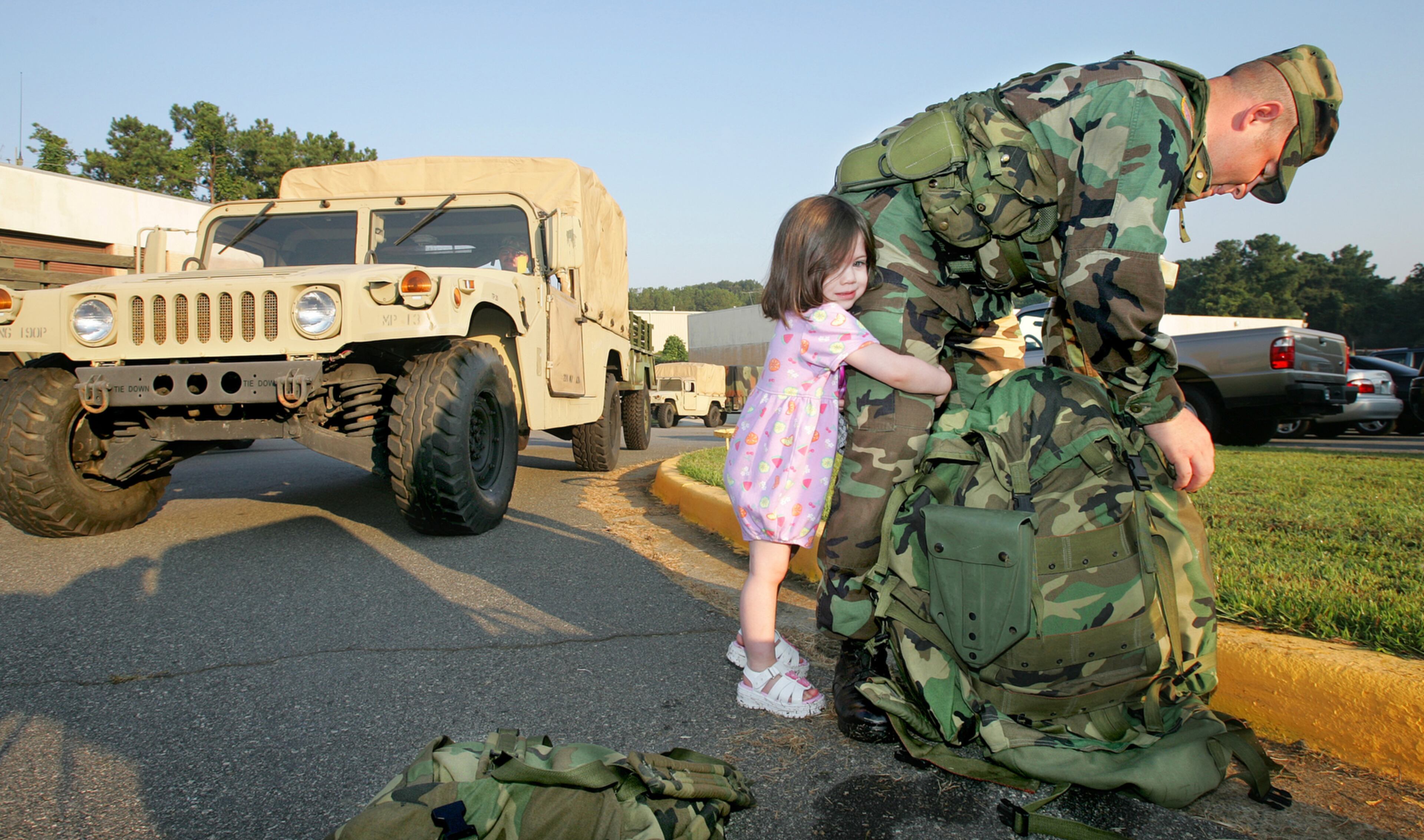 050902- KENNESAW/COBB COUNTY - Mary De La Torre -3 hugs her father, Bezaleel De La Torre as he packed up his gear to head out for duty from the Georgia Army National armory in Kennesaw at 1901 McCollum Parkway which deployed Military Police personnel toward the storm ravaged Gulf Coast Friday.(JOHN SPINK/AJC staff)