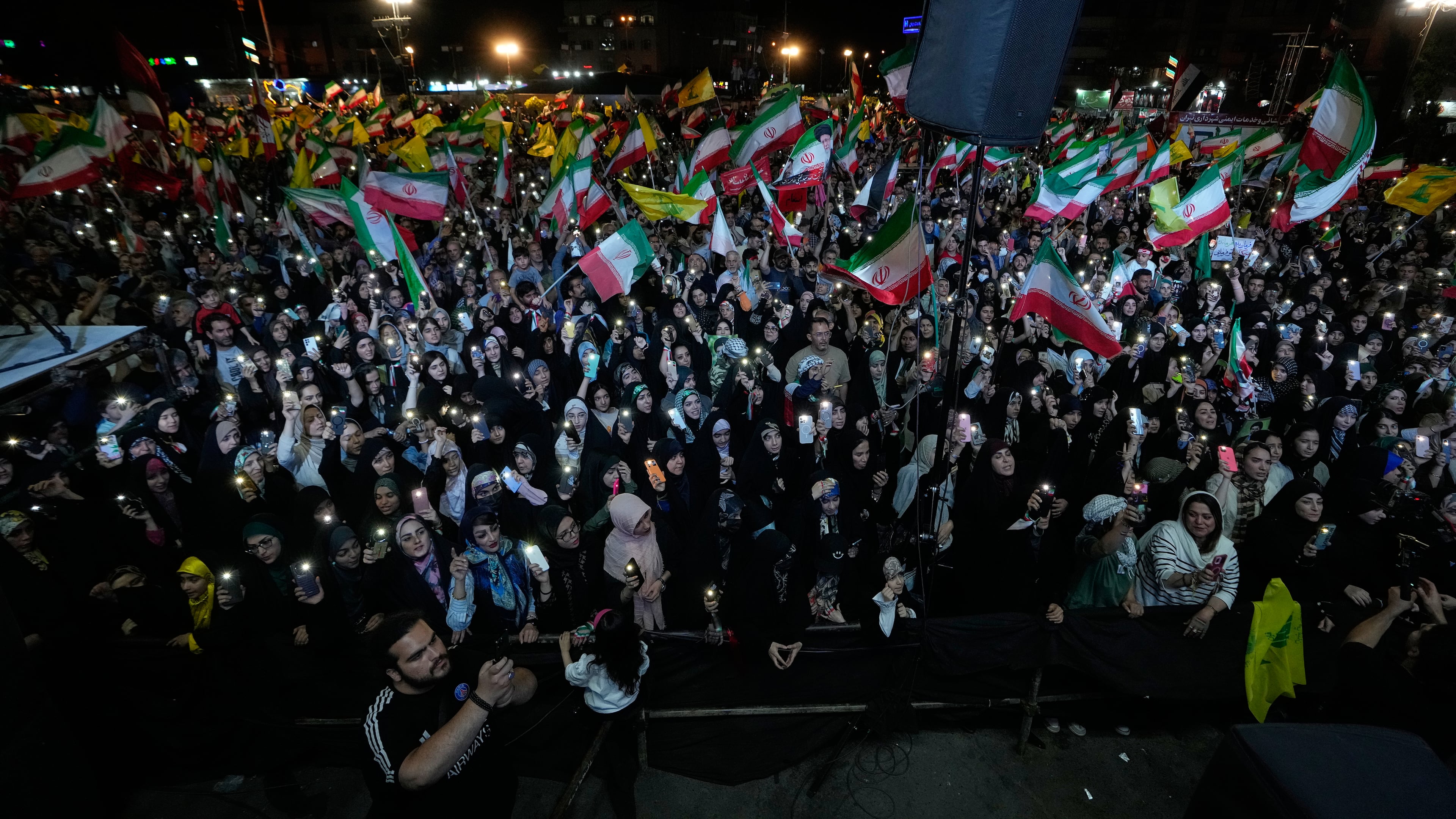 Demonstrators wave Iranian flags and flags of Lebanon's militant Hezbollah group during a pro-government gathering at Islamic Revolution Square in Tehran, Iran, Saturday, May 30, 2026. (AP Photo/Vahid Salemi)