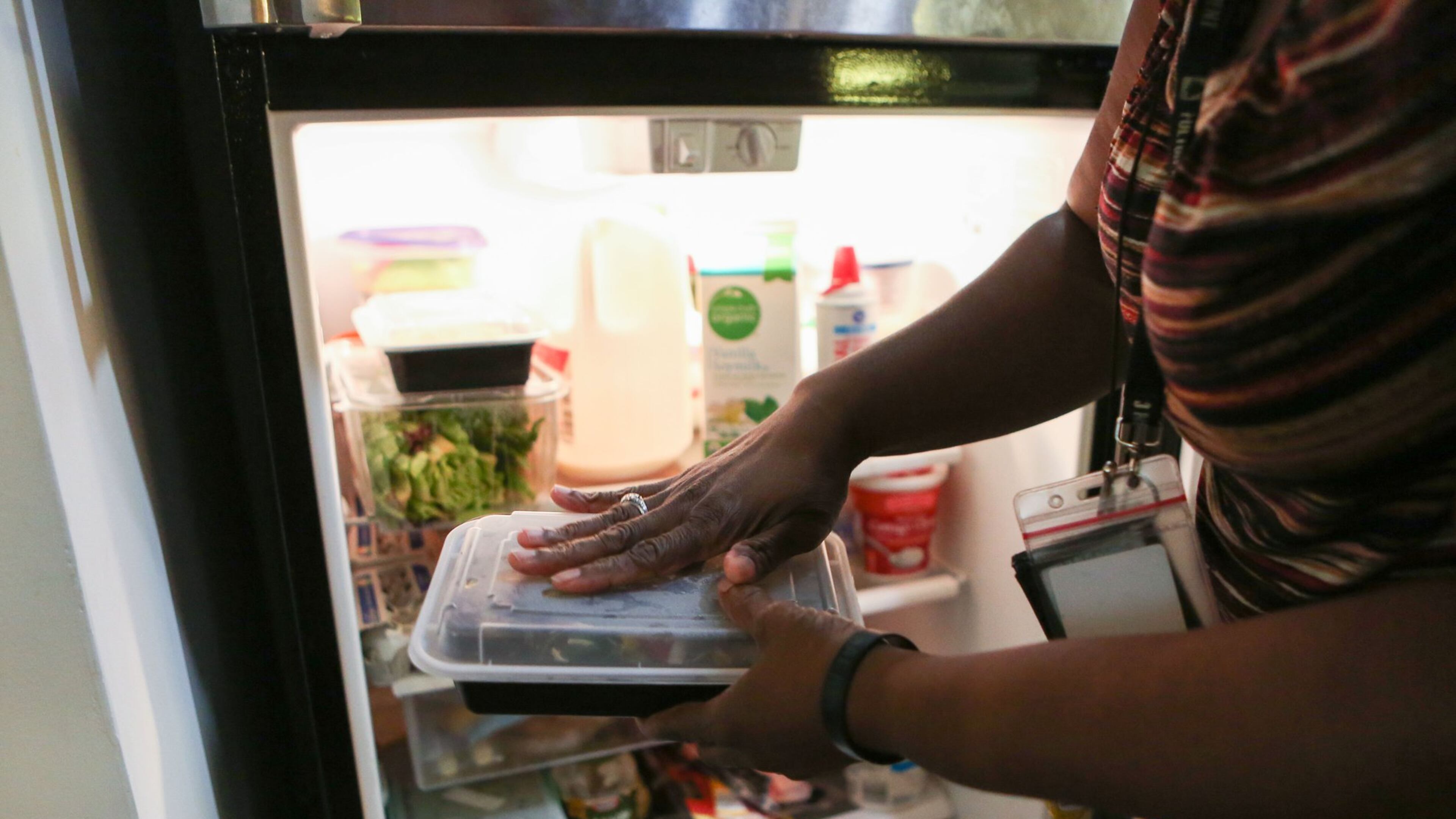 A health inspector takes a box of food out of Ligaya Figueras’ refrigerator to feel if the temperature is correct. Figueras’ kitchen scored a 44 and she received a “U” for unsatisfactory. EMILY JENKINS/ EJENKINS@AJC.COM