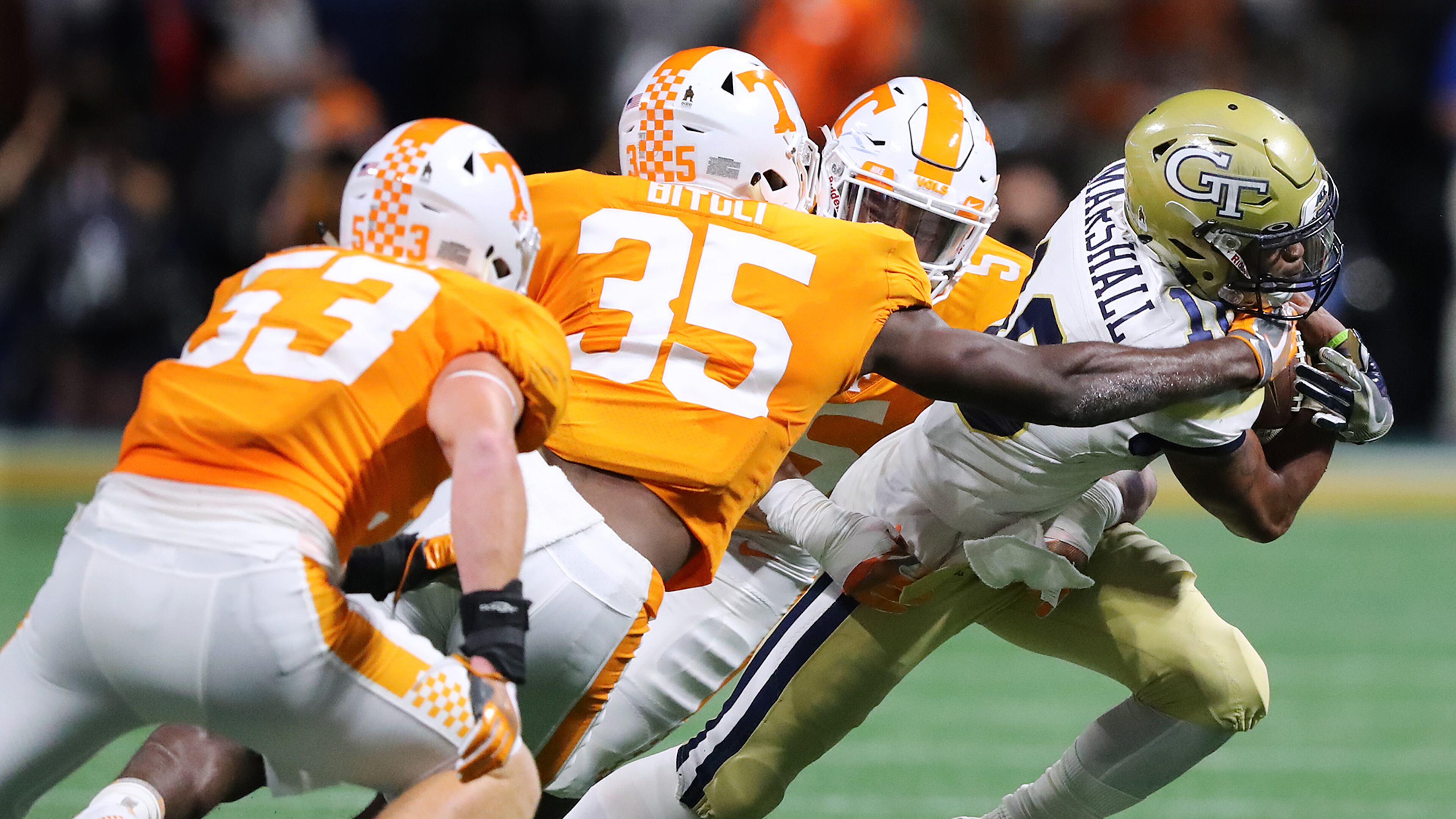 Georgia Tech quarterback TaQuon Marshall tries to run through three Tennessee defenders in the second quarter Monday night. (Curtis Compton/ccompton@ajc.com)