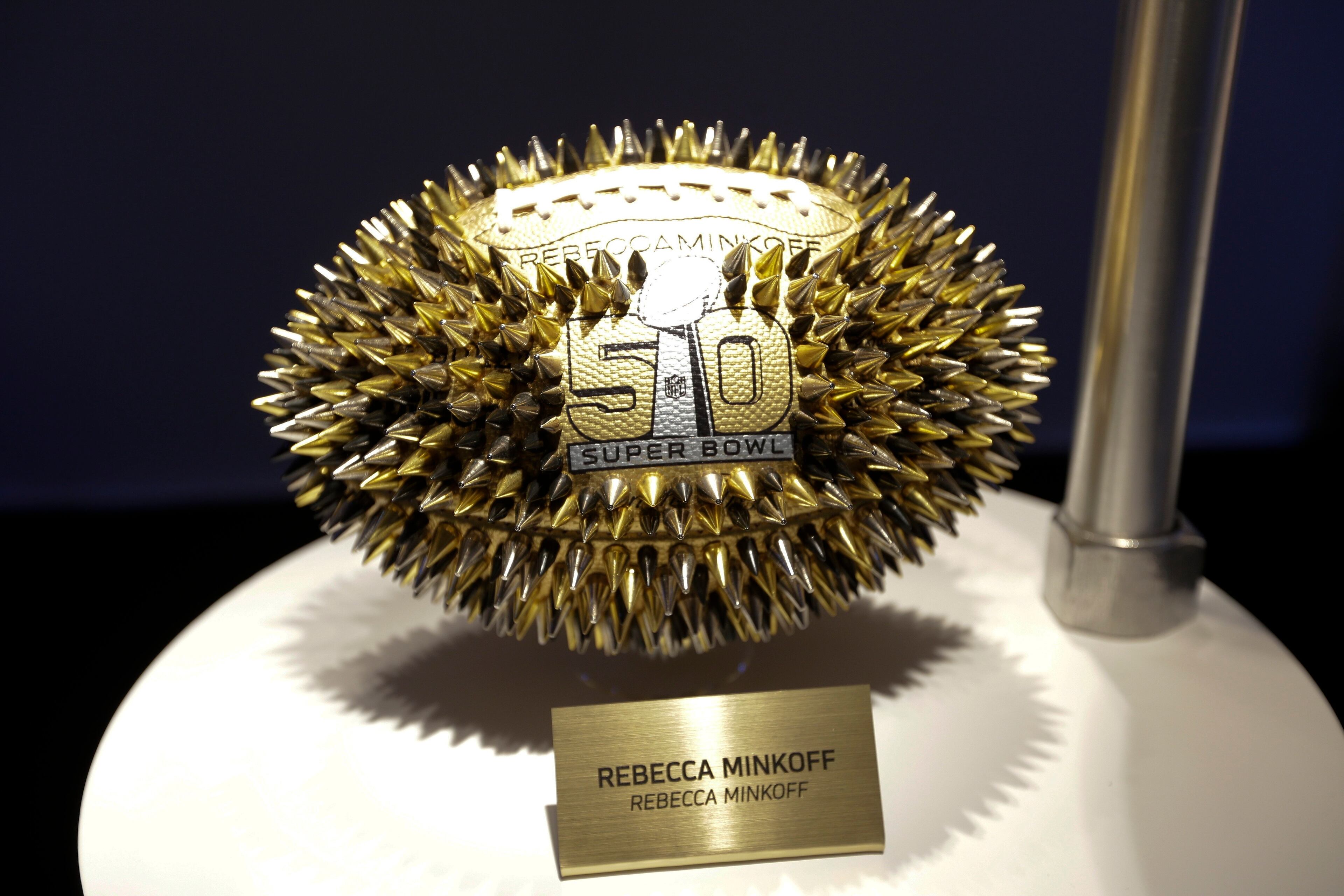 A Rebecca Minkoff designed football is displayed at the unveiling of the CFDA Footballs Wednesday, Jan. 20, 2016, at the NFL headquarters in New York. In celebration of Super Bowl 50 and in support of the NFL Foundation, the NFL and the Council of Fashion Designers of America have collaborated on 50 Bespoke Designer Footballs created by CFDA Members. (AP Photo/Frank Franklin II)