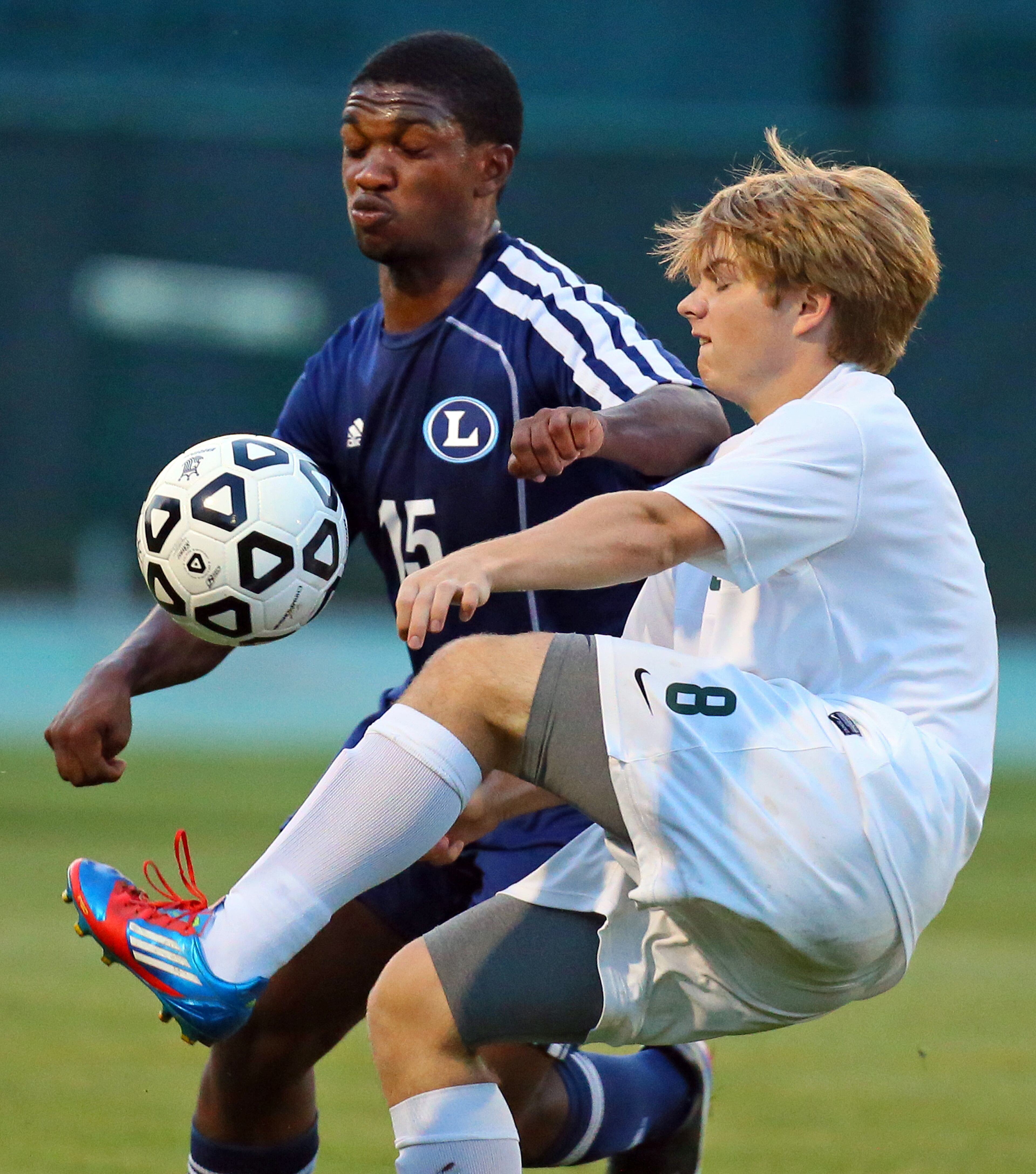 Lovett High School's Nick Grant (left) collides with Westminster High's Tommy Pastor as they go for the ball.