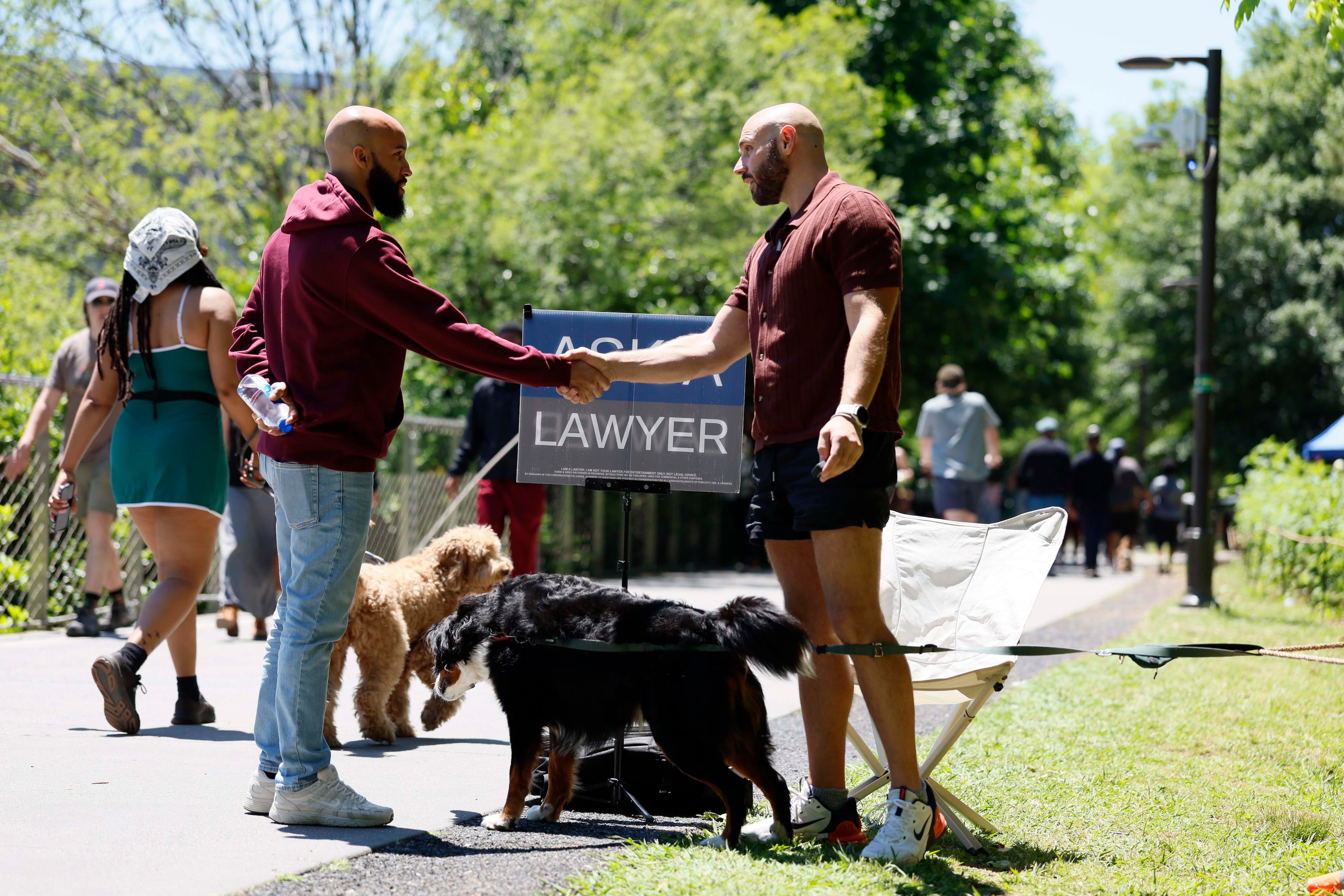 Edlin Veras (left), an assistant professor of sociology at Swarthmore College near Philadelphia, greets Atlanta attorney Cody Randall at the Beltline on Sunday, May 3, 2026. (Miguel Martinez/AJC)