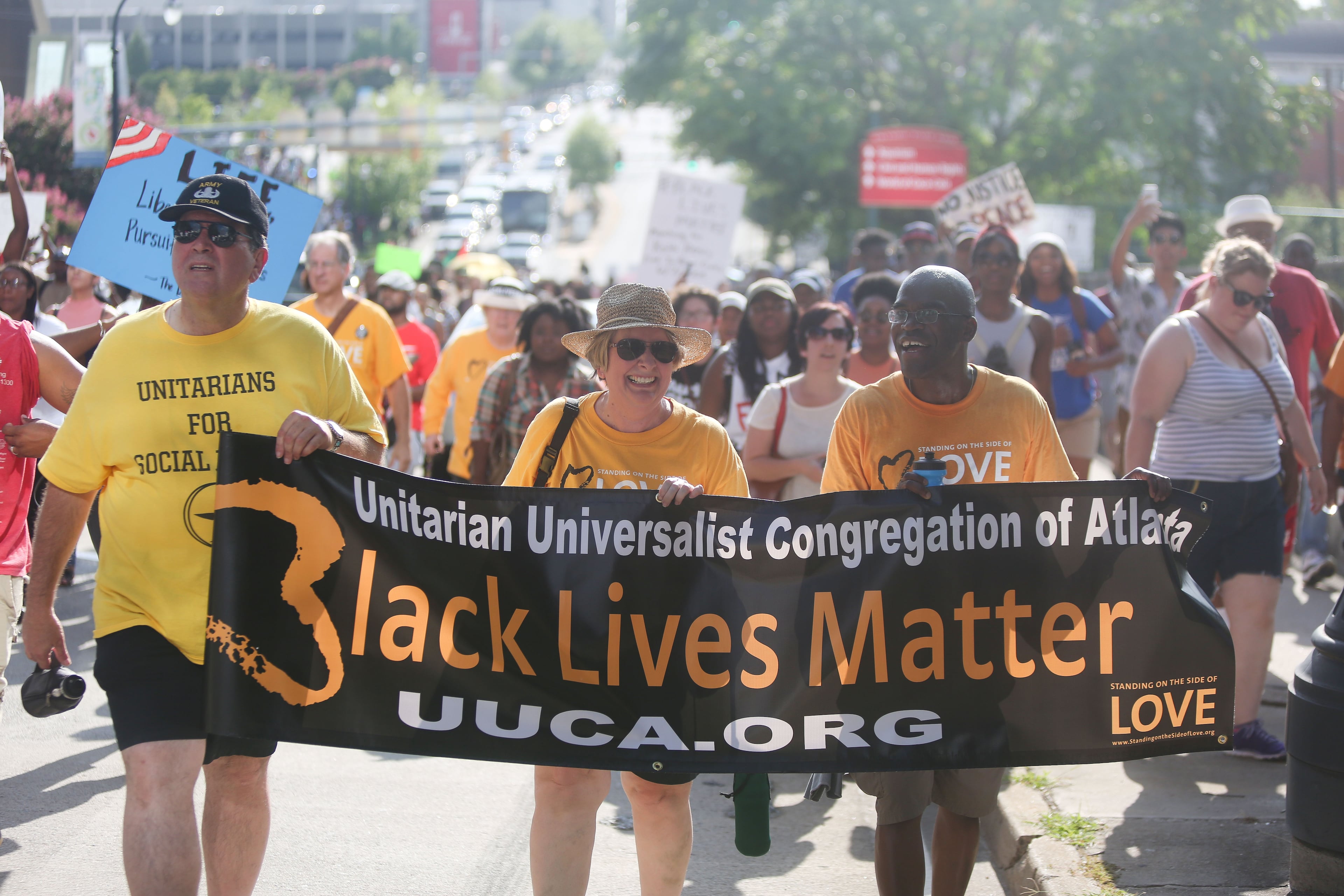 Victor Crouch, Sally Riddle and Pat Riddle of Unitarian Universalist Church march in the protest of recent shootings on Friday, July 8, 2016. Protesters marched from the Center for Civil and Human Rights on Ivan Allen Jr. Boulevard to the CNN Center on Marietta St in response to recent shootings and civil rights issues. The rallies and march was sponsored by the NAACP and Black Lives Matter.