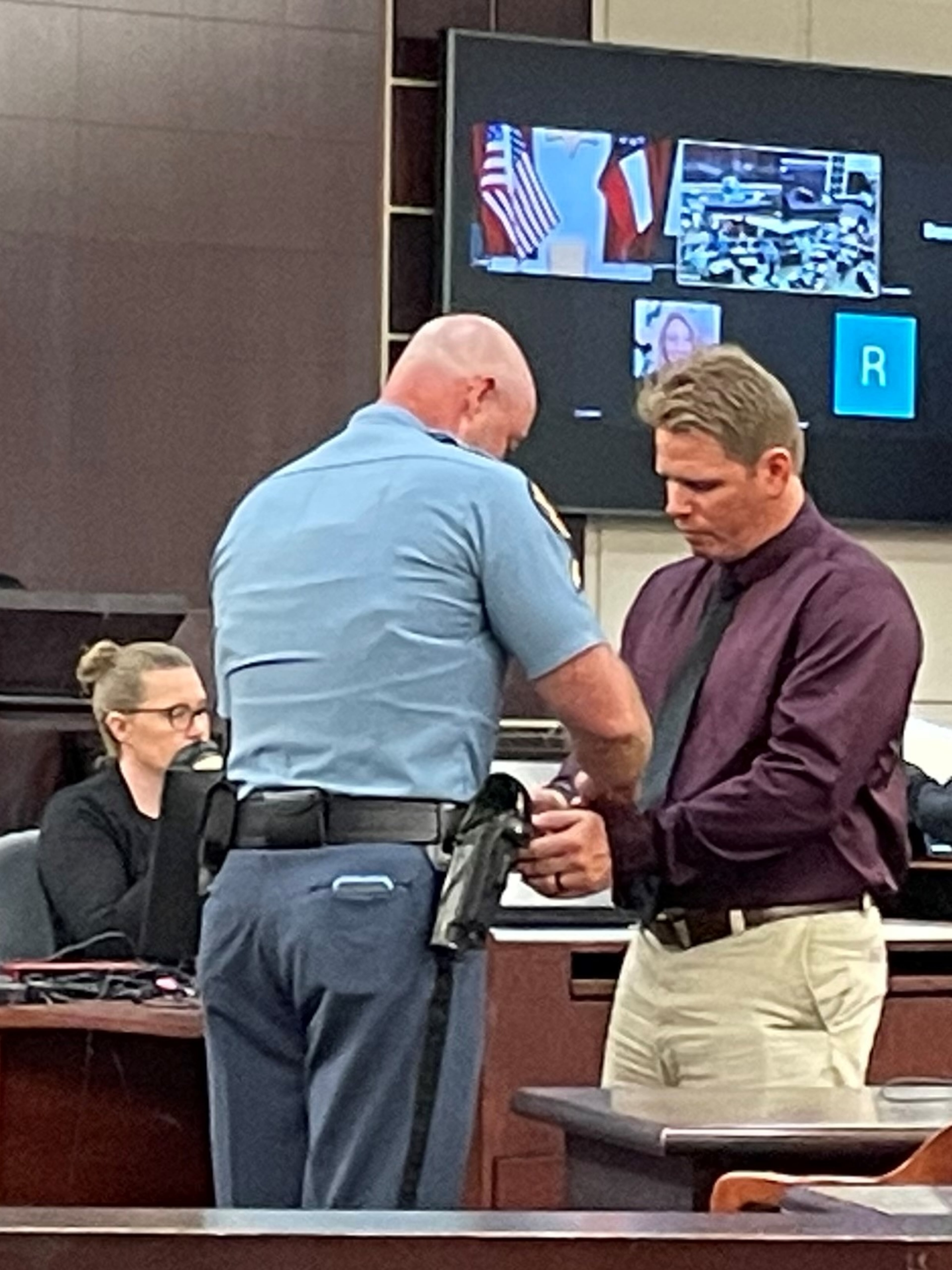 Former Georgia correctional officer Daniel Farmer (right) was taken into custody Wednesday, July 10, in Columbia County after pleading guilty to charges related to the stabbing of Terry Anthony. Farmer admitted he popped the lock on a cell door, which allowed orderly Donte Wyatt to enter Anthony's cell. (Carrie Teegardin/AJC)