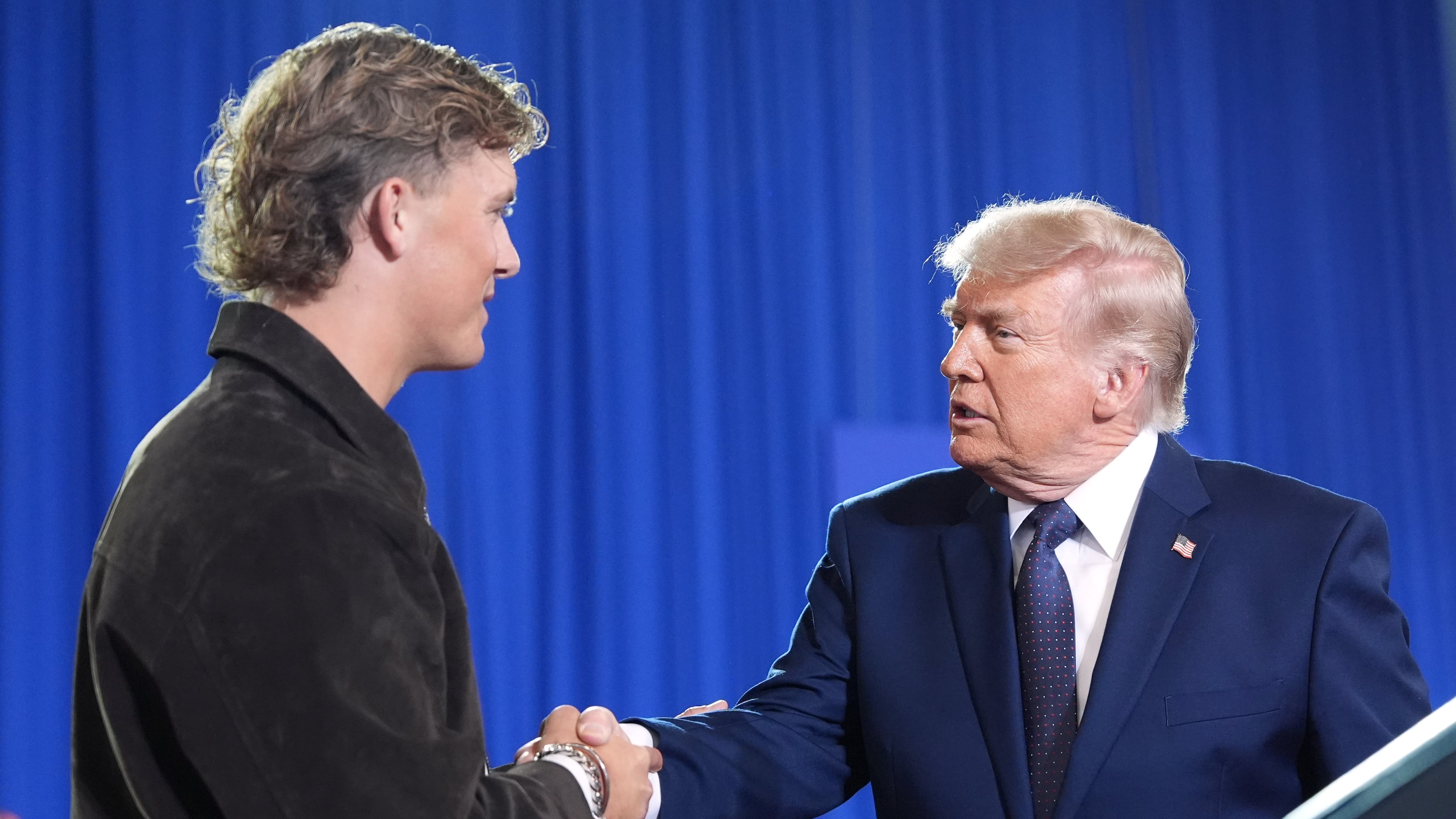President Donald Trump shakes hands with New York Giants quarterback Jaxson Dart as he arrives to speak at Rockland Community College, Friday, May 22, 2026, in Suffern, N.Y. (AP Photo/Alex Brandon)