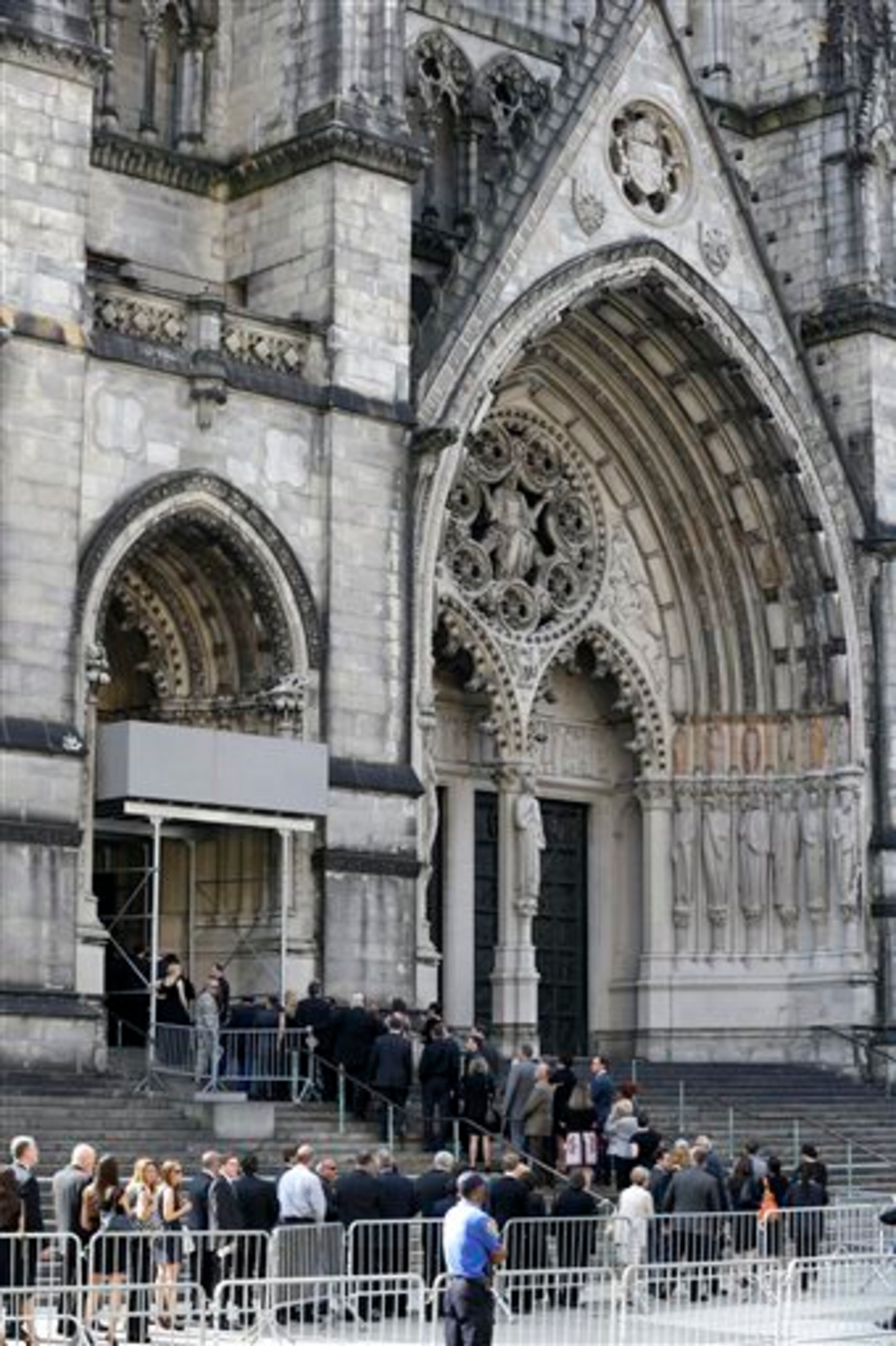 People walk into Cathedral Church of Saint John the Divine during for funeral services actor James Gandolfini, Thursday, June 27, 2013, in New York. Gandolfini, who played Tony Soprano in the HBO show "The Sopranos", died while vacationing in Italy last week. (AP Photo/Julio Cortez)