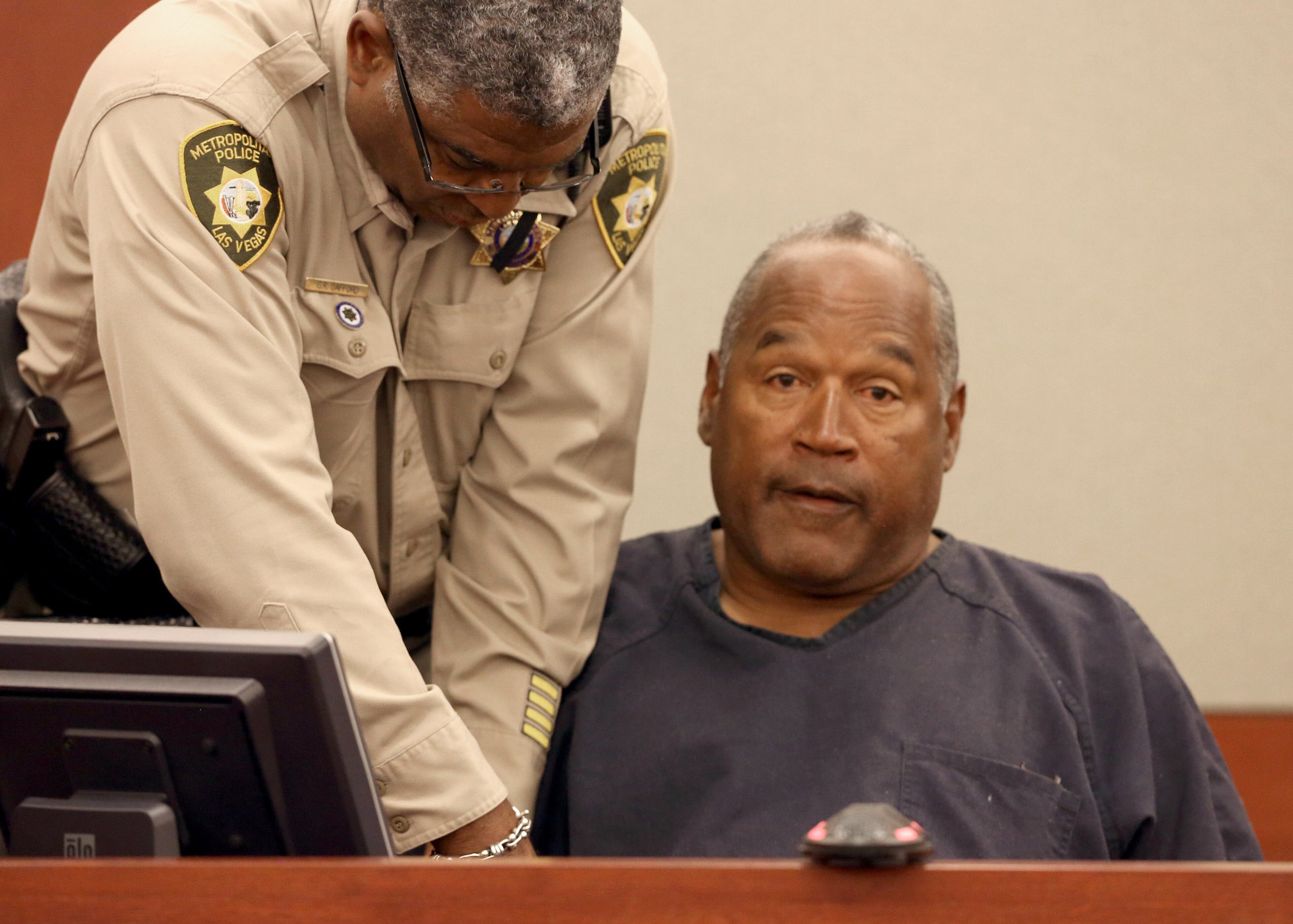O.J. Simpson has one of his handcuffs removed as he takes the witness stand during an evidentiary hearing in Clark County District Court, Wednesday, May 15, 2013 in Las Vegas. Simpson, who is currently serving a nine to 33-year sentence in state prison as a result of his October 2008 conviction for armed robbery and kidnapping charges, is using a writ of habeas corpus, to seek a new trial, claiming he had such bad representation that his conviction should be reversed. (AP Photo/Las Vegas Review-Journal, Jeff Scheid, Pool)