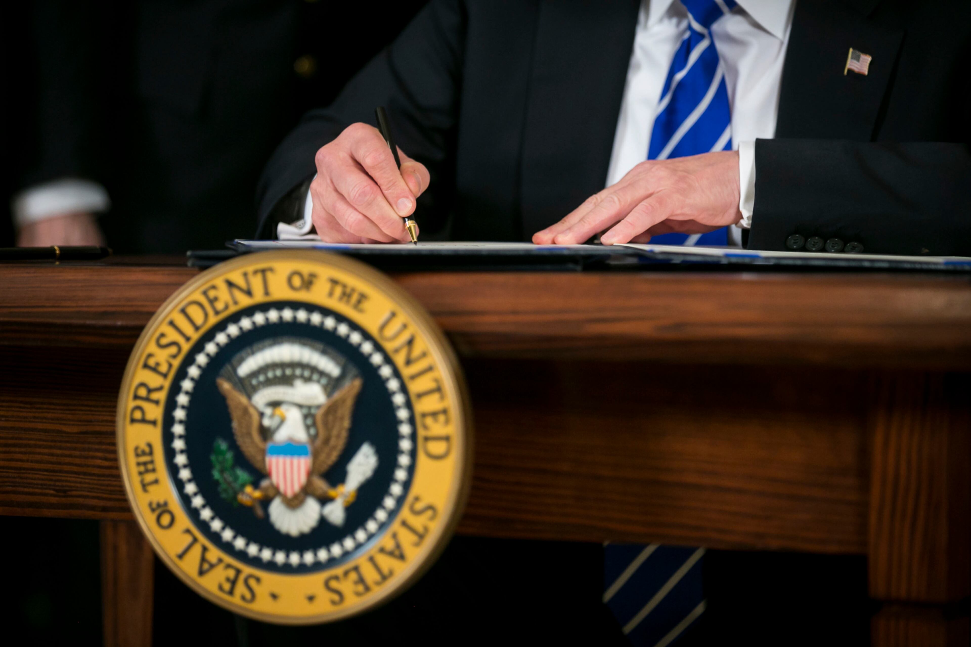 President Donald Trump signs a bill in the Diplomatic Reception Room at the White House in Washington, June 2, 2017. Trump signed two bills, the American Law Enforcement Heroes Act and Public Safety Officers Benefits Improvement Act. (Al Drago/The New York Times)