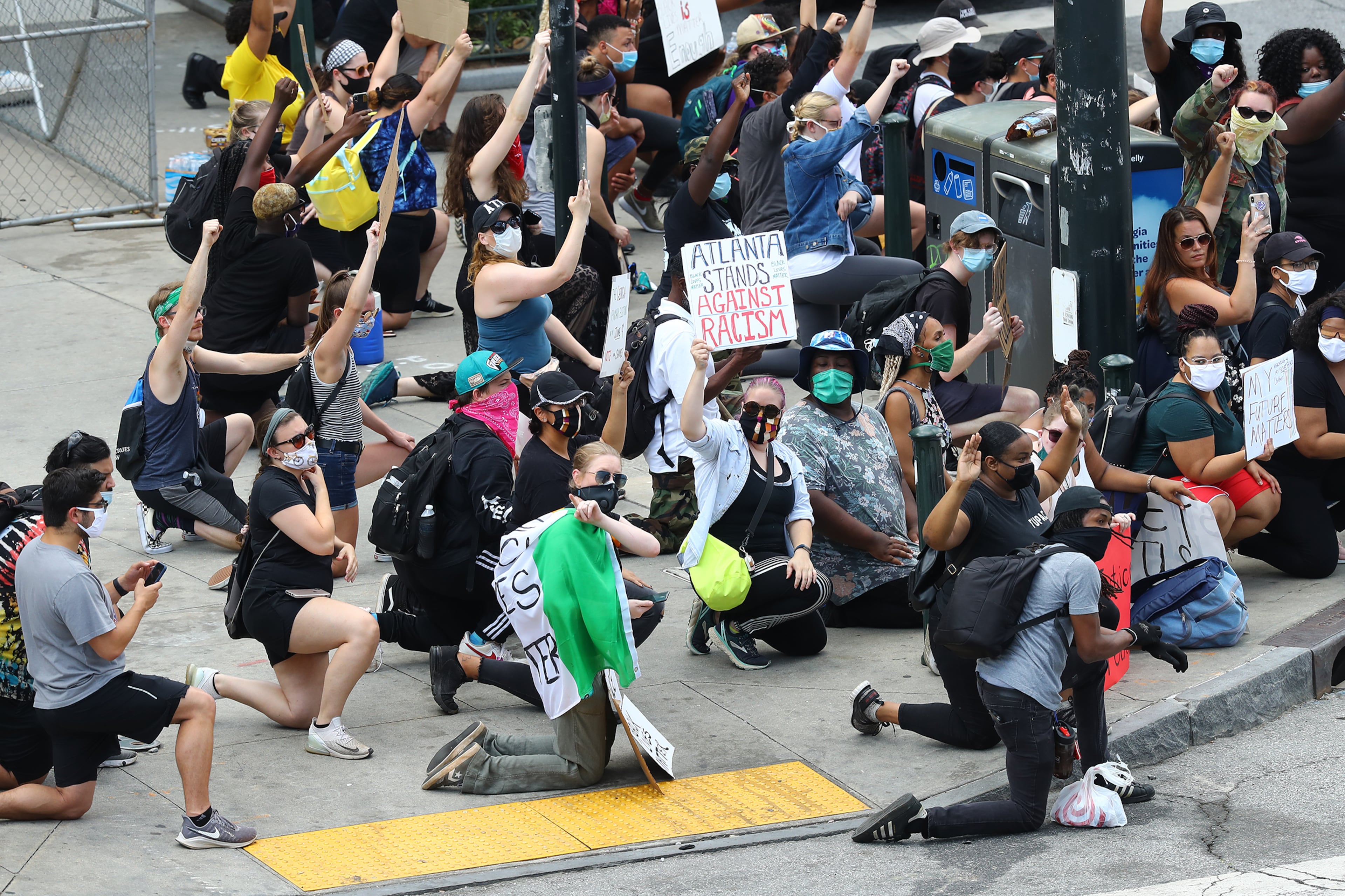 060220 Atlanta: Protesters kneel on the sidewalk outside the CNN Center at Olympic Park during a fifth day of protests over the death of George Floyd on Tuesday, June 2, 2020, in Atlanta. Curtis Compton ccompton@ajc.com