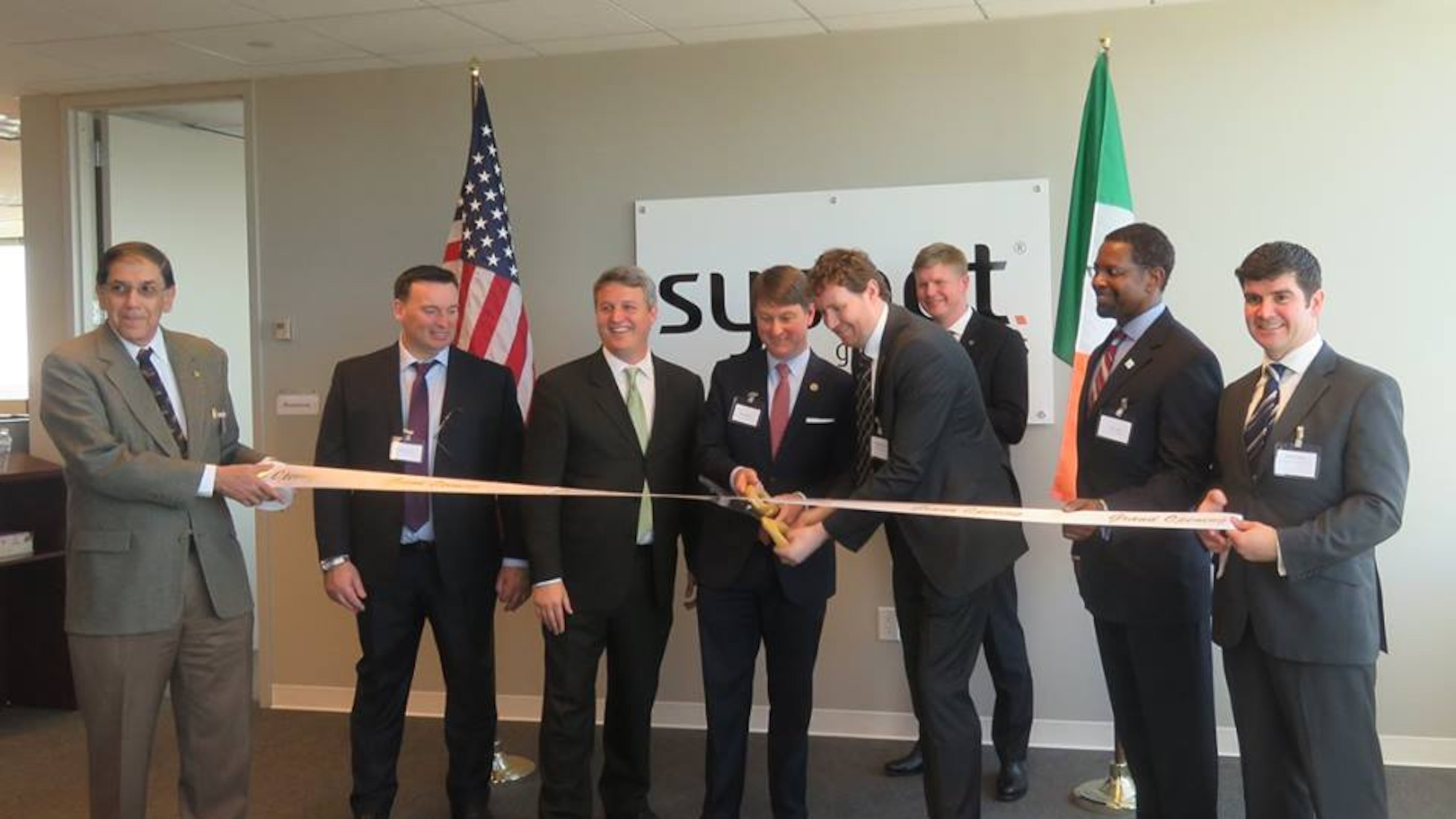The ribbon has been cut on Sysnet's Brookhaven location, which will eventually create 500 jobs for DeKalb County. Shown are Brookhaven Chamber of Commerce President Alan Goodman, Sysnet Chief People Officer Patrick Condren, Brookhaven Mayor John Ernst, Commissioner Pat Wilson of the Ga Dept of Economic Development, Sysnet CEO Gabriel Moynagh, Consul General of Ireland Shane Stephens, Decide DeKalb Development Authority President Ray Gilley and Sysnet U.S. GM John Browne.