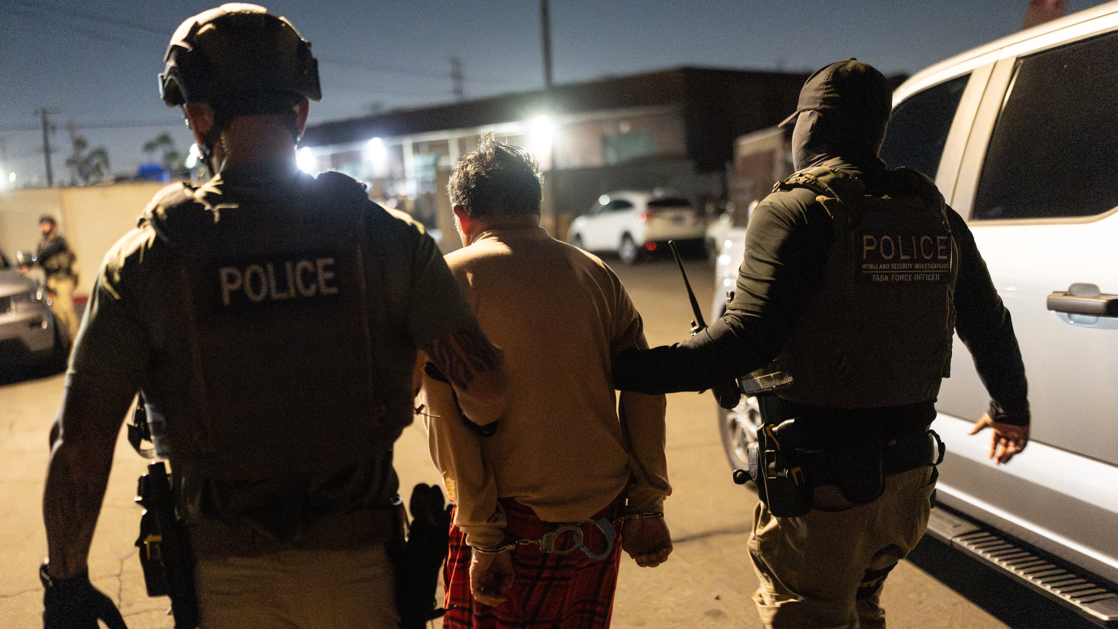 Homeland Security Investigations task force officers escort a suspect accused of illegally registering to vote during a federal operation in Commerce, Calif., Monday, Oct. 19, 2026. (AP Photo/Jae C. Hong)