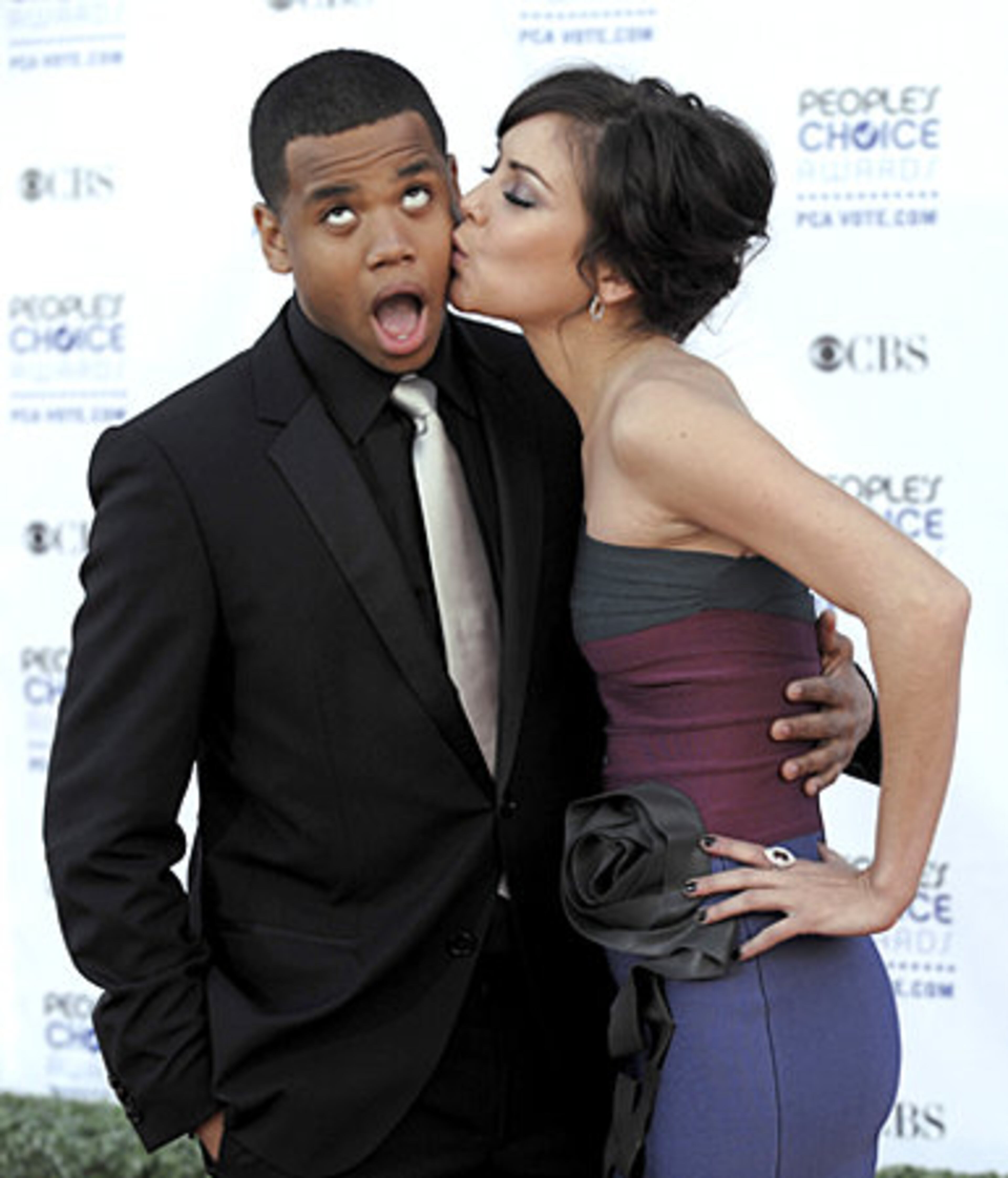 Jessica Stroup, right, kisses Tristan Wilds as they arrive.