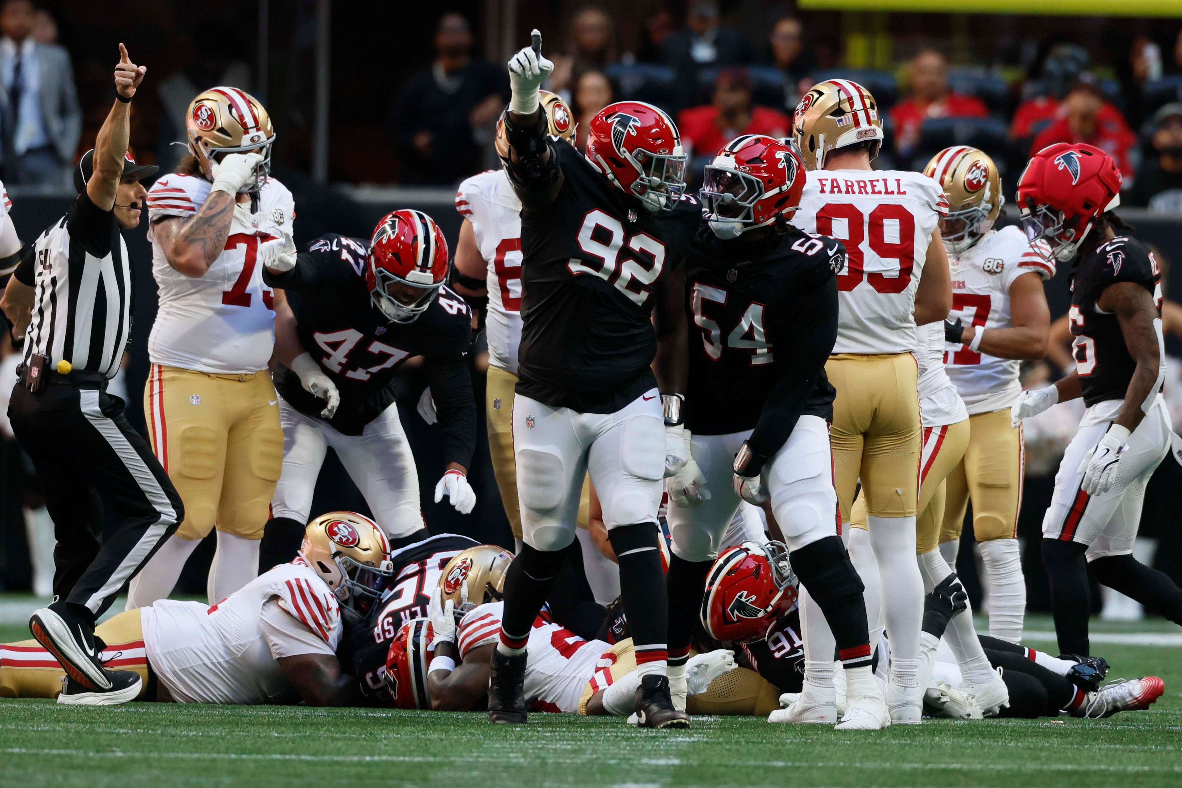 Atlanta Falcons defensive tackle Maason Smith (center) and Atlanta Falcons defensive end Brandon Dorlus celebrate after recovering a fumble during the first half of a football game against the San Francisco 49ers at Mercedes-Benz Stadium in Atlanta, GA, on Sunday, Oct. 25, 2026. (Miguel Martinez/AJC)