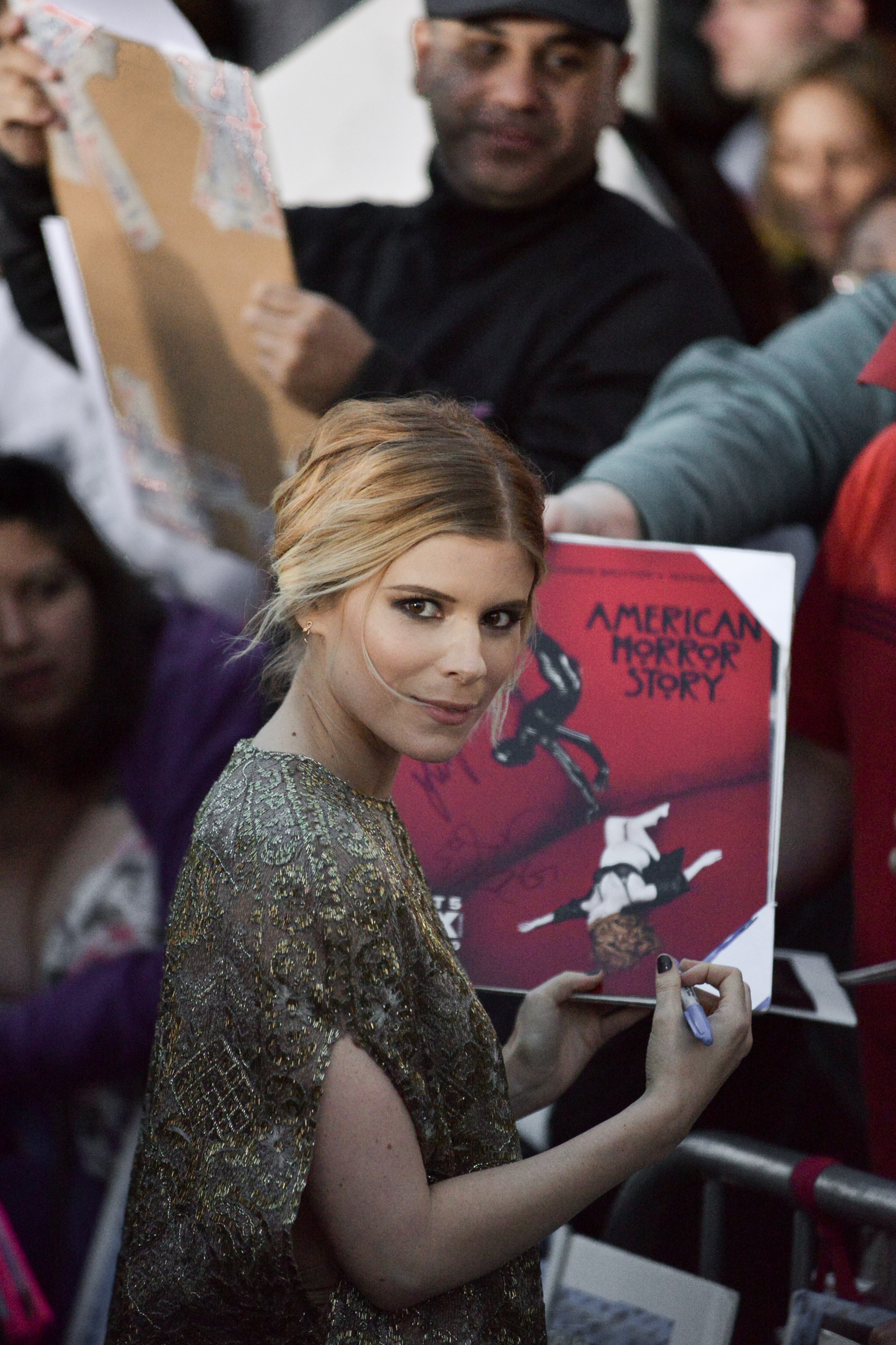 Kate Mara signs autographs for fans at the LA Premiere Of "Transcendence" on Thursday, April 10, 2014, in Los Angeles.