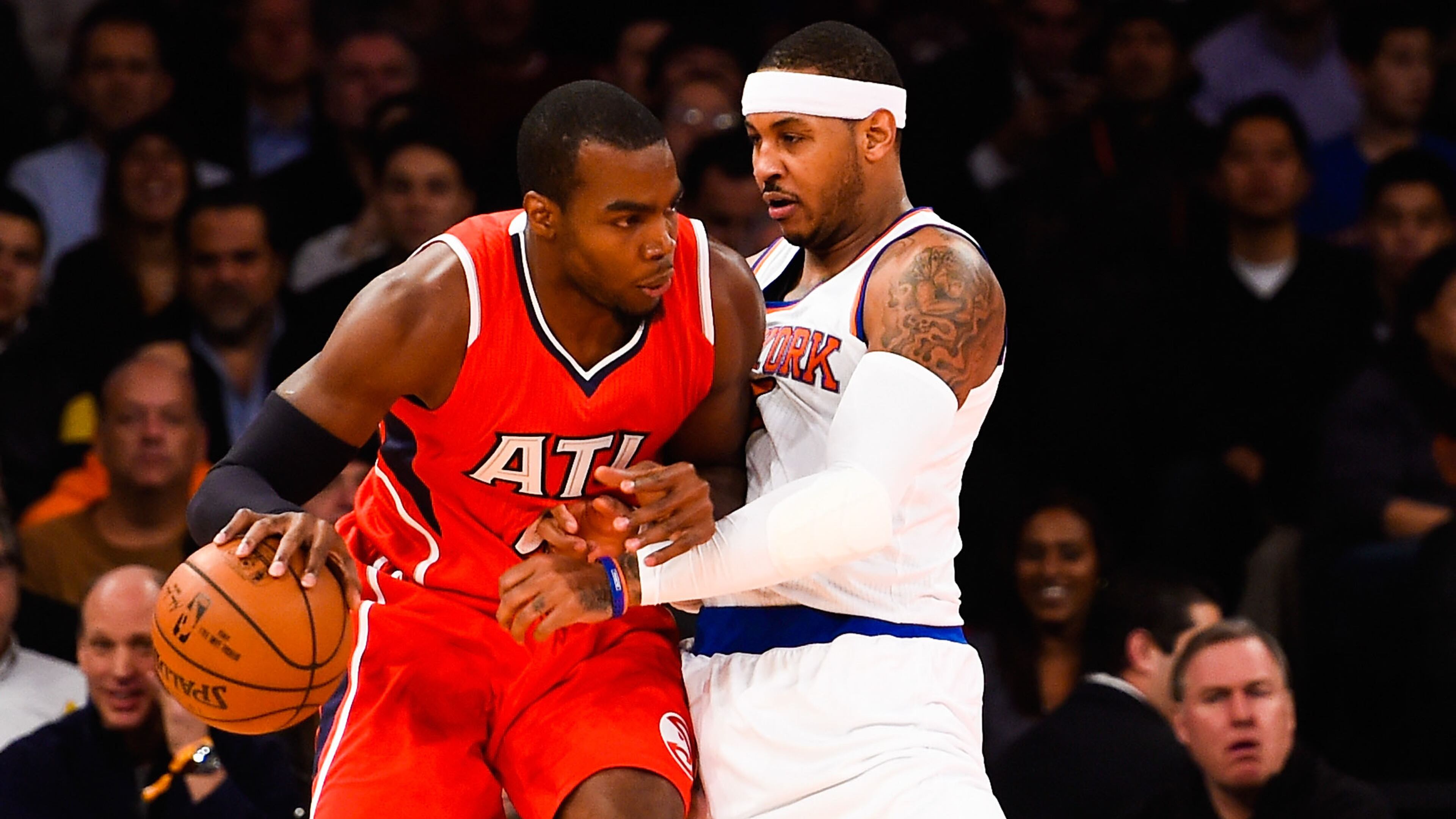 NEW YORK, NY - NOVEMBER 10: Carmelo Anthony #7 of the New York Knicks guards Paul Millsap #4 of the Atlanta Hawks in the first half at Madison Square Garden on November 10, 2014 in New York City. NOTE TO USER: User expressly acknowledges and agrees that, by downloading and/or using this photograph, user is consenting to the terms and conditions of the Getty Images License Agreement. (Photo by Alex Goodlett/Getty Images)