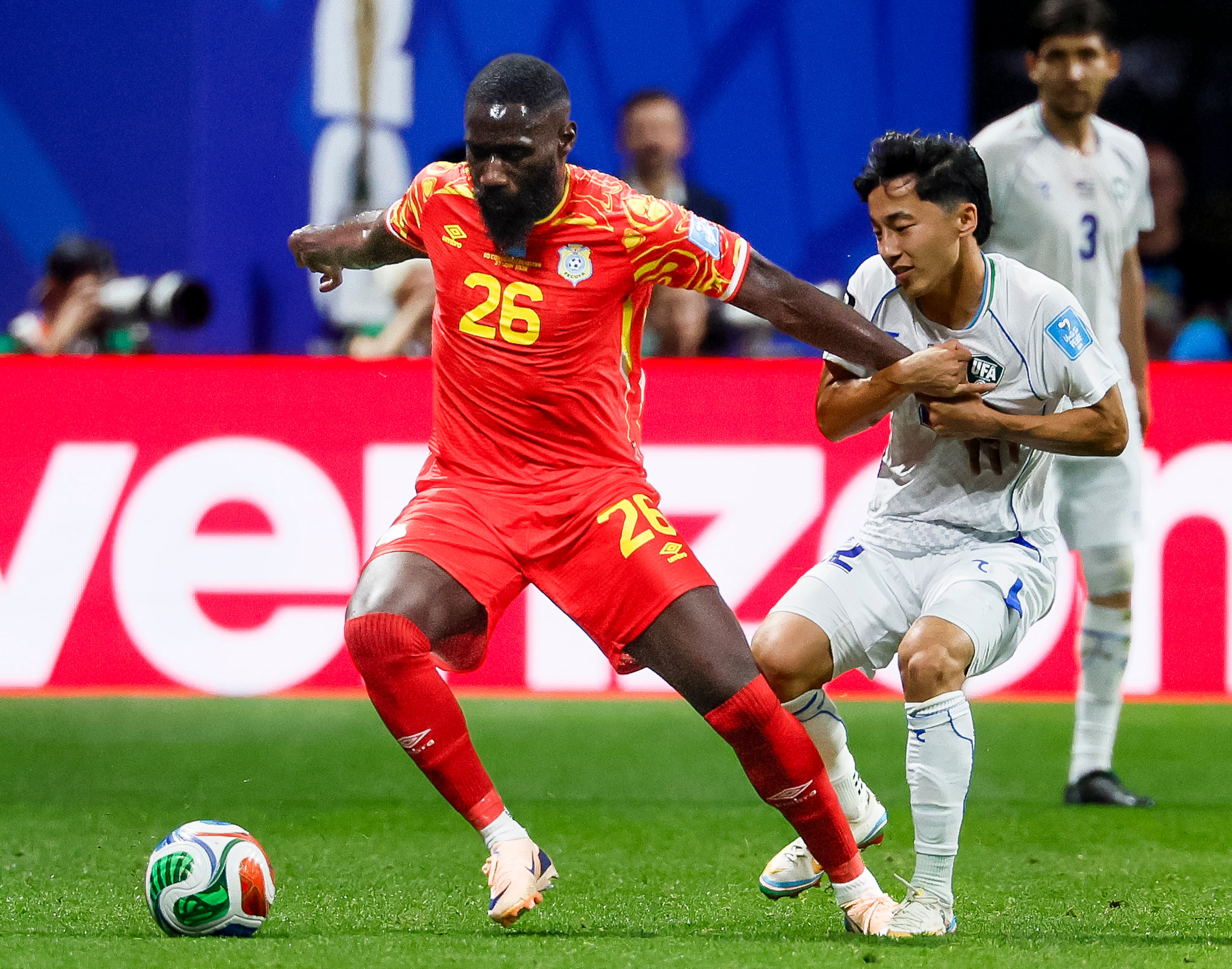Congo defender Arthur Masuaku (left) struggles to break free from Uzbekistan midfielder Abbosbek Fayzullaev (right) during the first half of a FIFA World Cup match at Atlanta Stadium (Mercedes-Benz Stadium) on Saturday, June 27, 2026, in Atlanta. (Miguel Martinez/AJC)