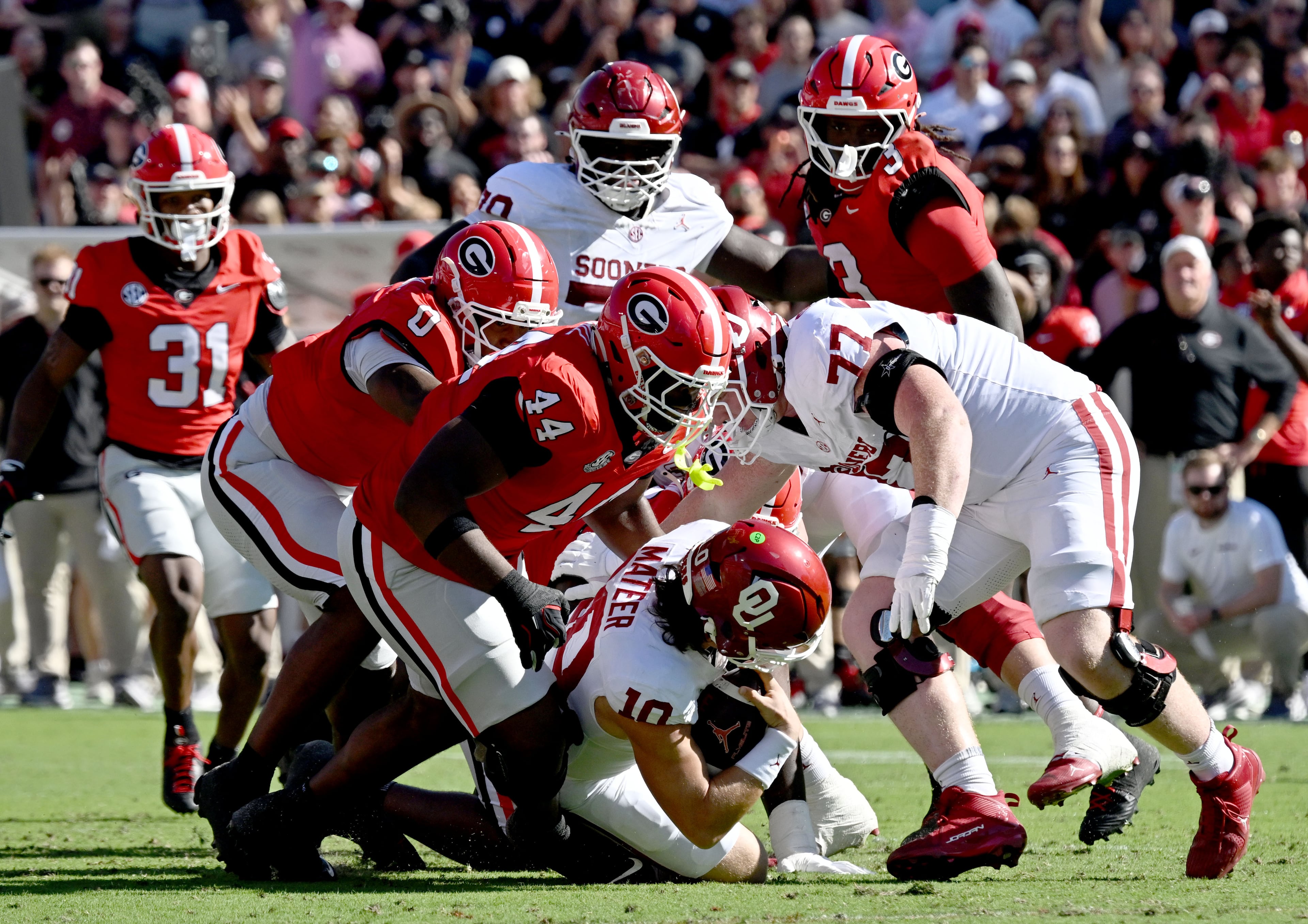 Oklahoma quarterback John Mateer is sacked by Georgia defensive lineman Jordan Hall during the first half of an NCAA football game at Sanford Stadium on Saturday, Sept. 26, 2026, in Athens, Ga. (Hyosub Shin/AJC)