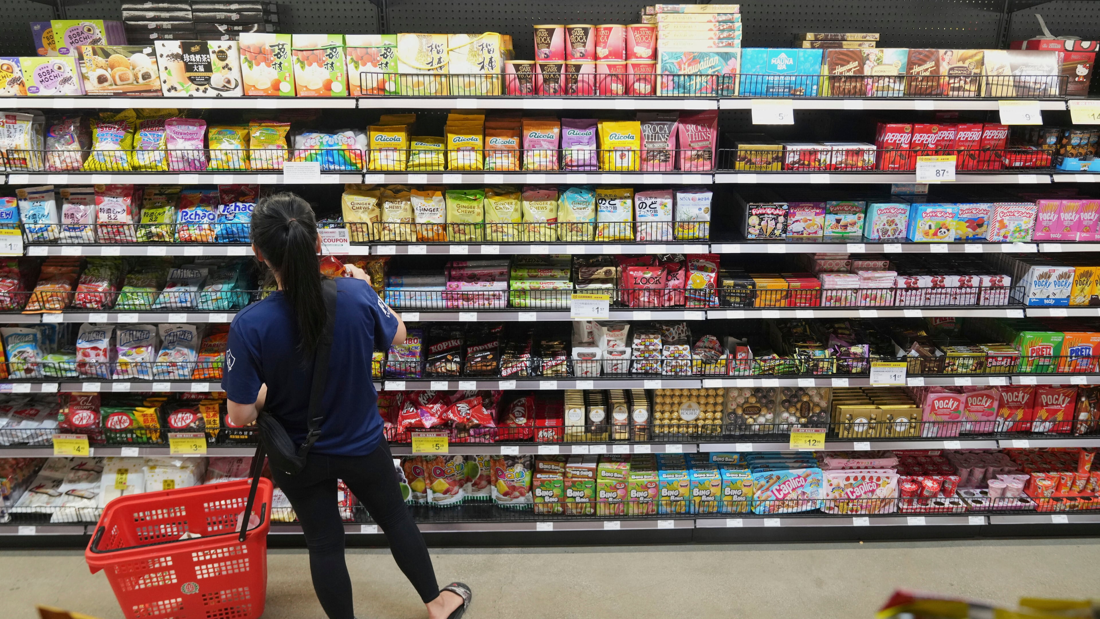 FILE - A customer buys Chinese made ginger candy at 99 Ranch Market, an Asian grocery store in Los Angeles, April 7, 2025. (AP Photo/Damian Dovarganes, File)