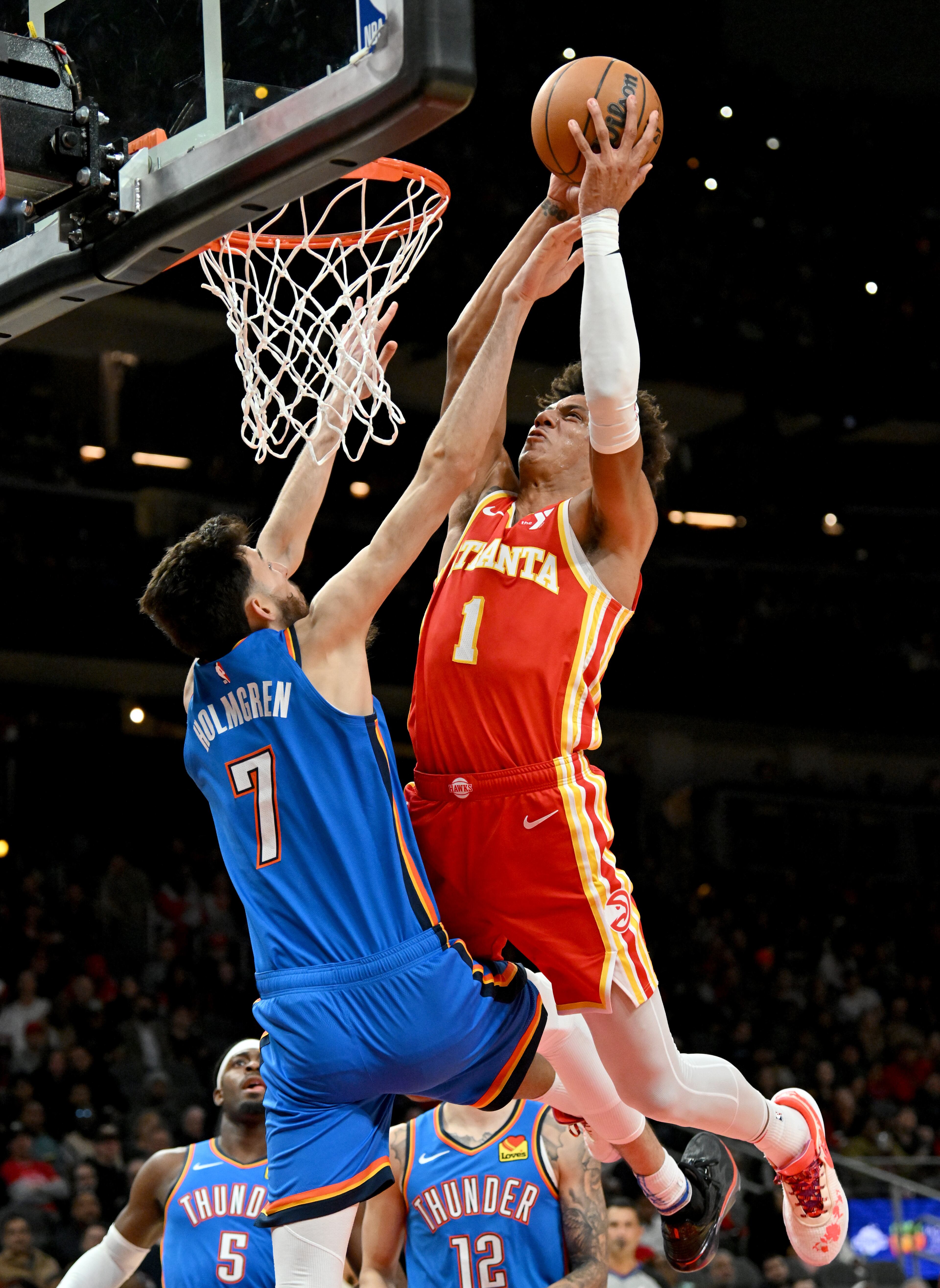 Atlanta Hawks forward Jalen Johnson (1) is fouled by Oklahoma City Thunder forward Chet Holmgren (7) as he goes to the basket during the first half in an NBA basketball game at State Farm Arena, Wednesday, December 3, 2024, in Atlanta. (Hyosub Shin / Hyosub.Shin@ajc.com)