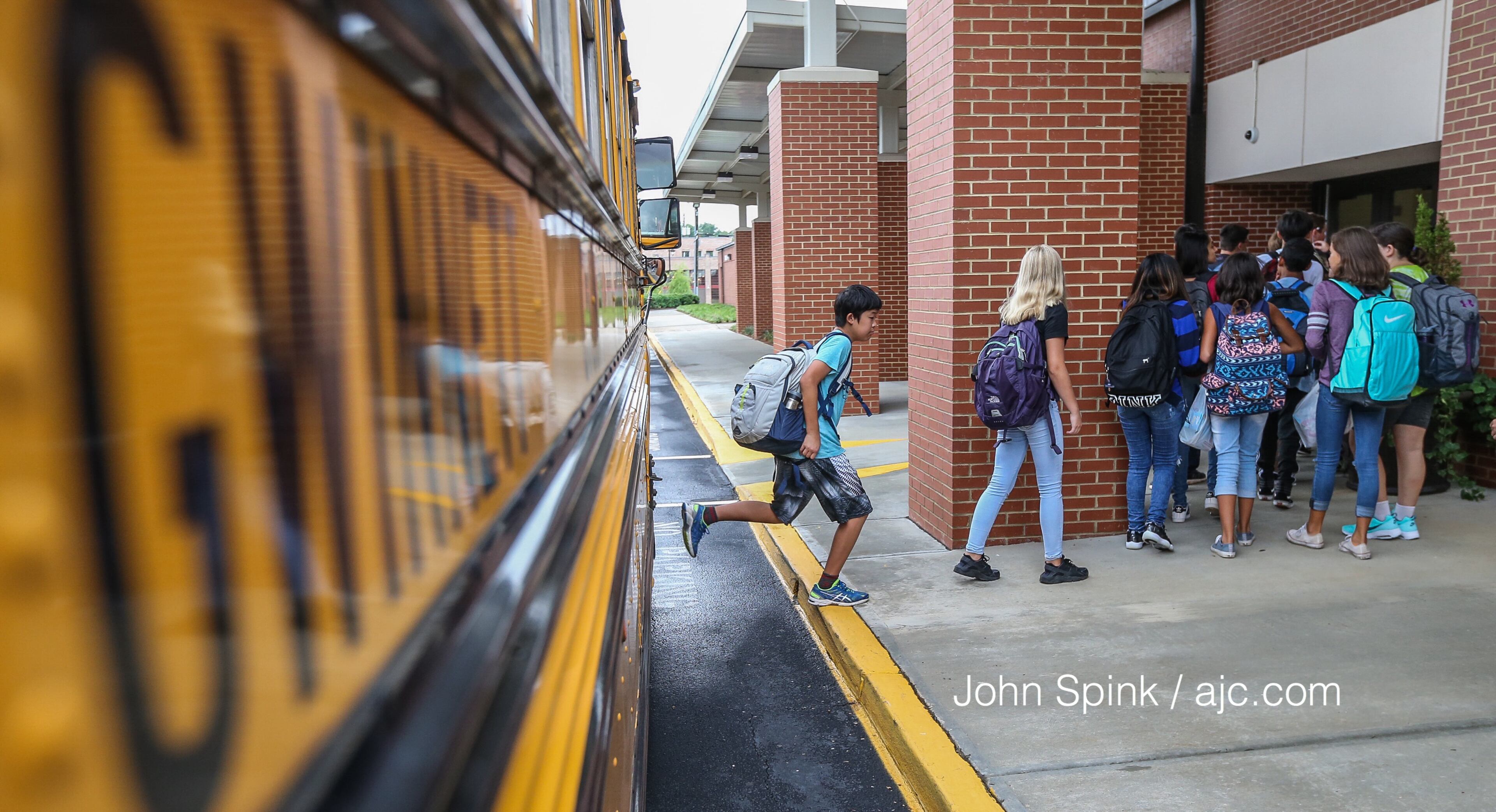 August 7, 2017 Lithonia; Fifth grade student Isaiah Brown, 10, enjoys the freedom of an open hallway as he is the first student to arrive for the first day of school at Edward L Bouie Elementary School on Monday, August 7, 2017, in Lithonia. Curtis Compton/ccompton@ajc.com