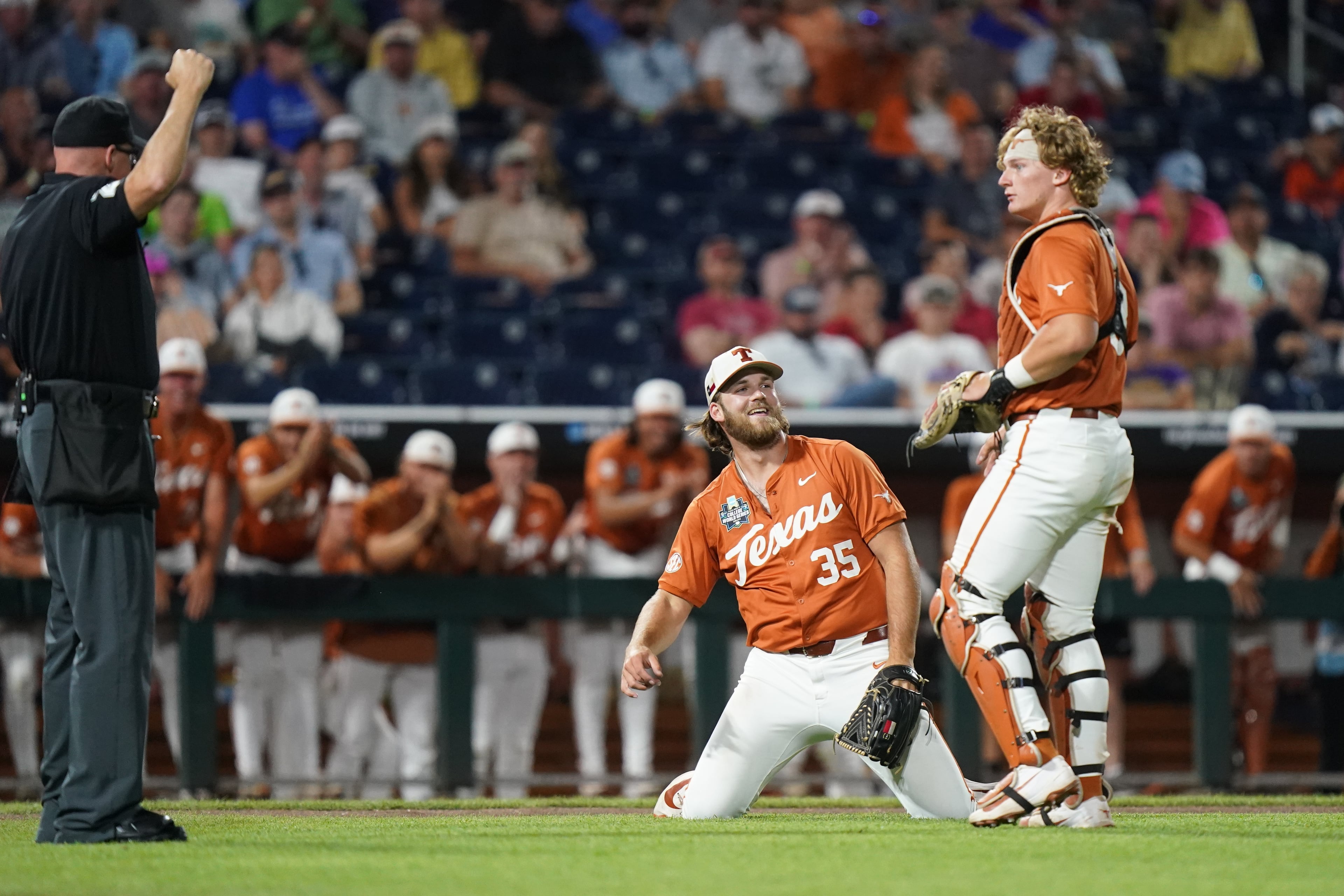 Texas pitcher Samuel Cozart (35) makes a diving catch in front of Texas catcher Carson Tinney (8) during an NCAA baseball College World Series elimination game against Georgia, Tuesday, June 16, 2026 in Omaha, Neb. Georgia won 2-0. (AP Photo/Vera Nieuwenhuis)