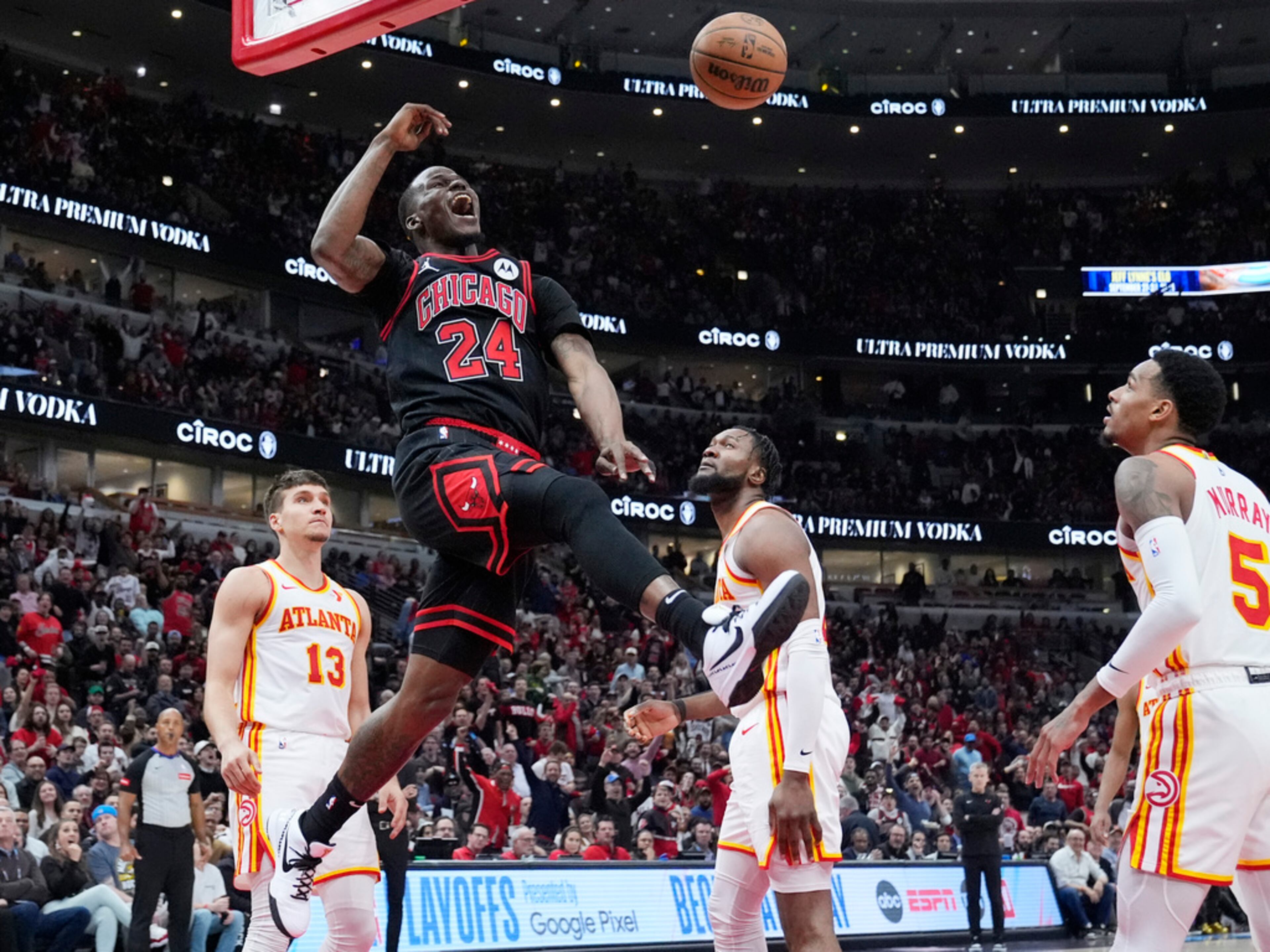 Chicago Bulls guard Javonte Green (24) reacts after dunking as Atlanta Hawks guard Bogdan Bogdanovic, left, forward Bruno Fernando, second from right, and Dejounte Murray look on during the second half of an NBA basketball play-in tournament game in Chicago, Wednesday, April 17, 2024. The Bulls won 131-116. (AP Photo/Nam Y. Huh)