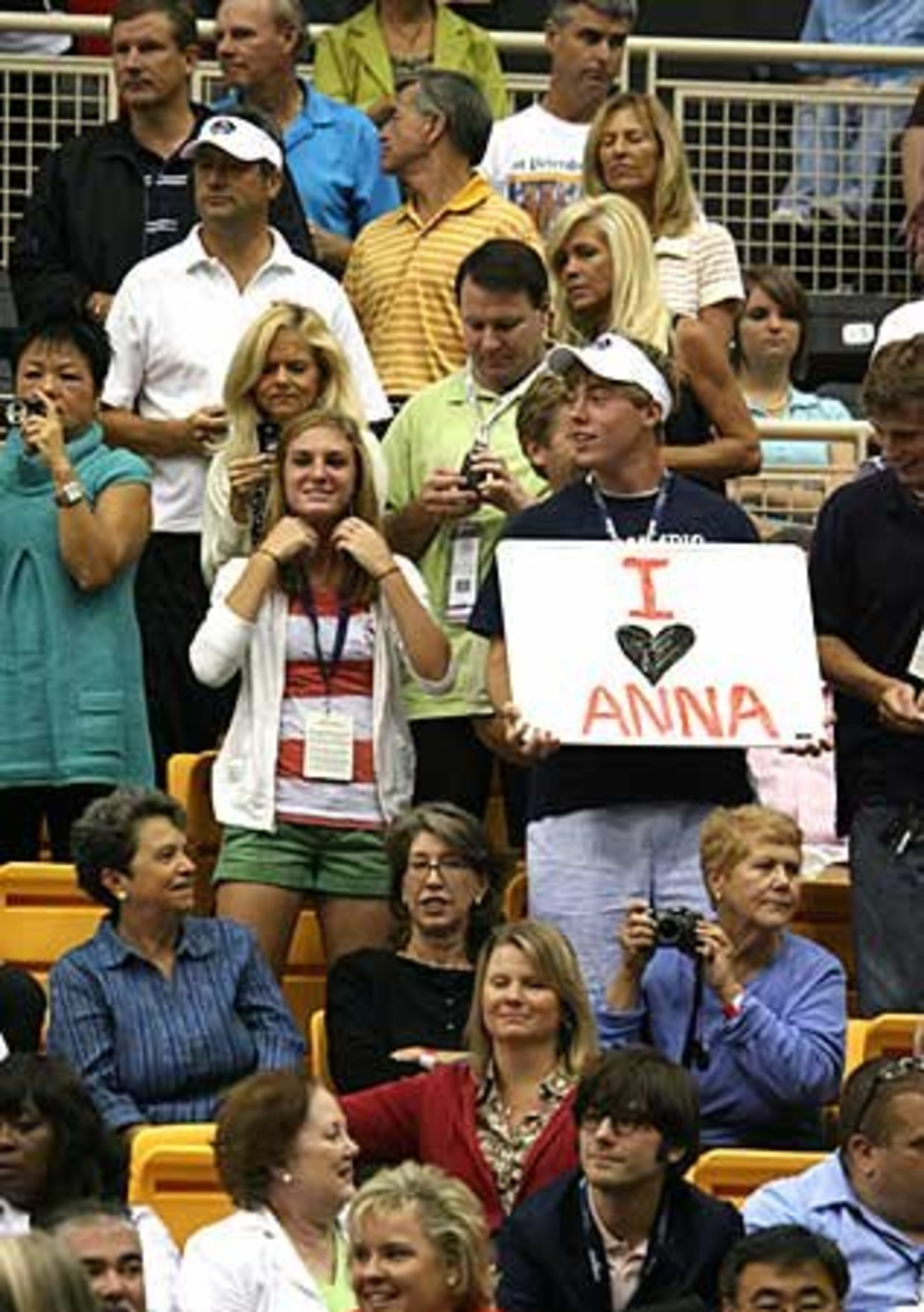 Fans in the stands show their love of Anna Kournikova during the Advanta WTT Smash Hits tennis event.