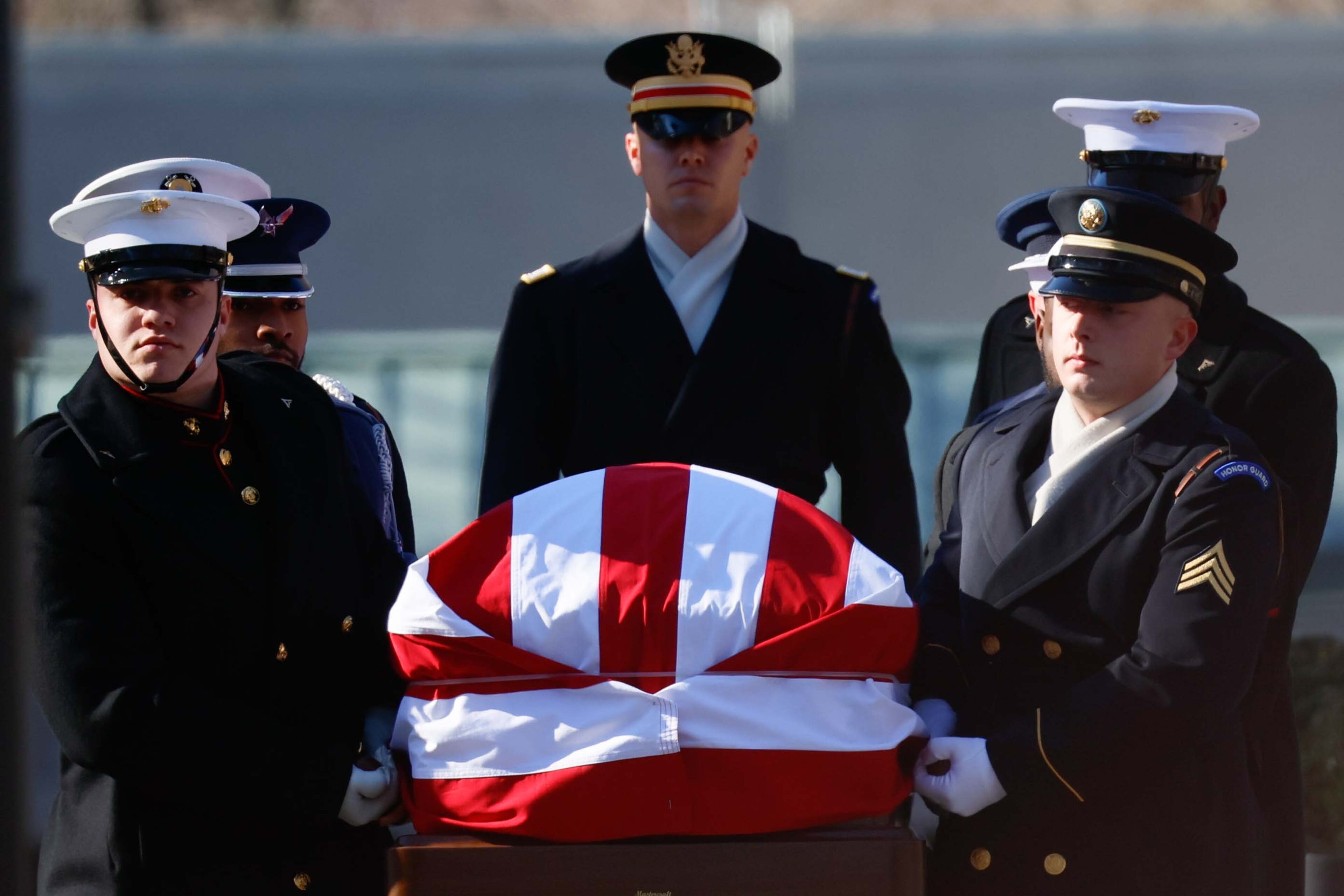 The Armed Forces Body Bearer team carries the casket of President Jimmy Carter to his hearse during his departure ceremony from Carter Presidential Center in Atlanta on Tuesday, January 7, 2025. (Miguel Martinez/AJC)
