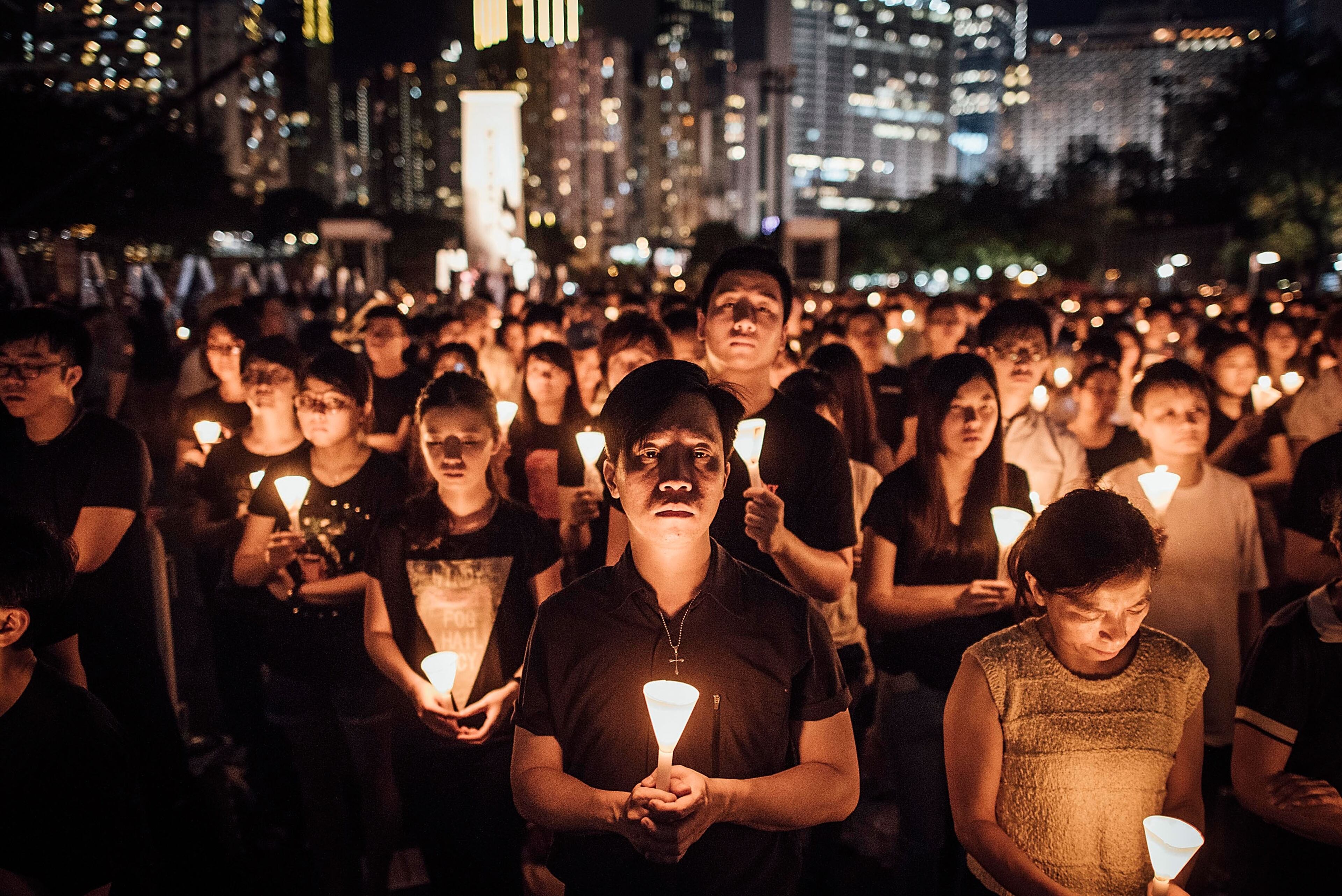 HONG KONG - JUNE 04: Participants take part at the candlelight vigil as they hold candles at Victoria Park on June 4, 2015 in Causeway Bay, Hong Kong. Hong Kong residents held a candlelight vigil as it marks 26th anniversary of 1989 student-led Tiananmen Square protest. (Photo by Anthony Kwan/Getty Images)