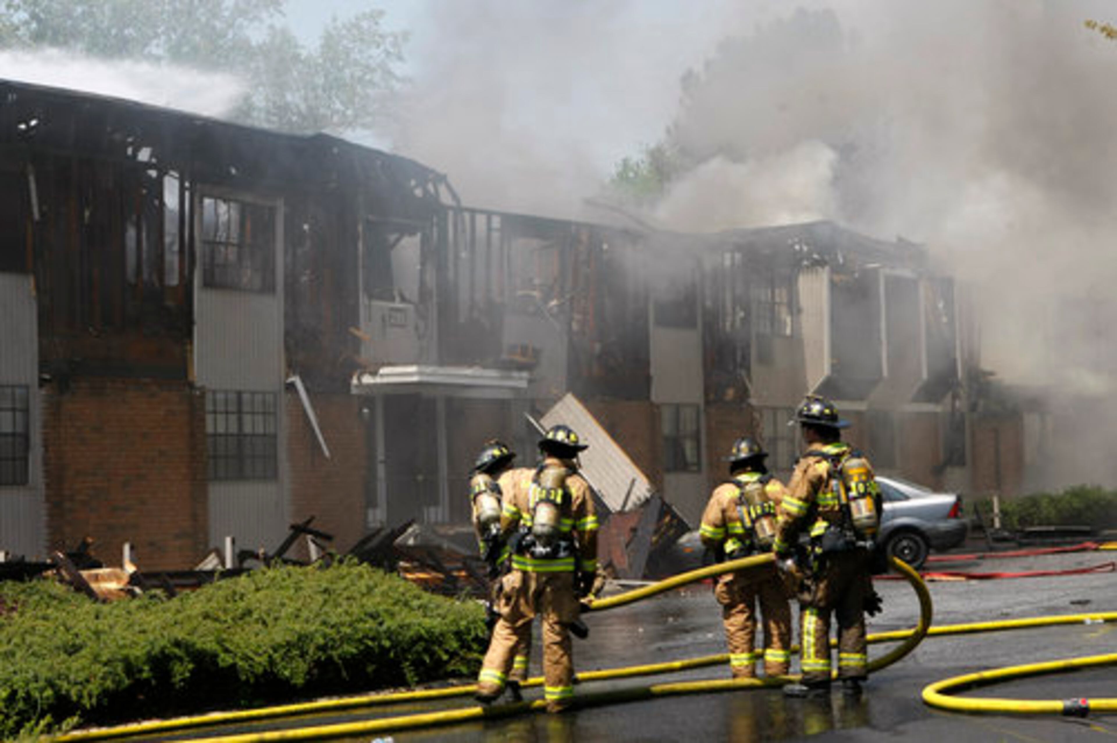 Sandy Springs firefighters wrap up the nearly extinguished fire at the Winding River Village Apartments in Sandy Springs on Tuesday, April 19, 2011.