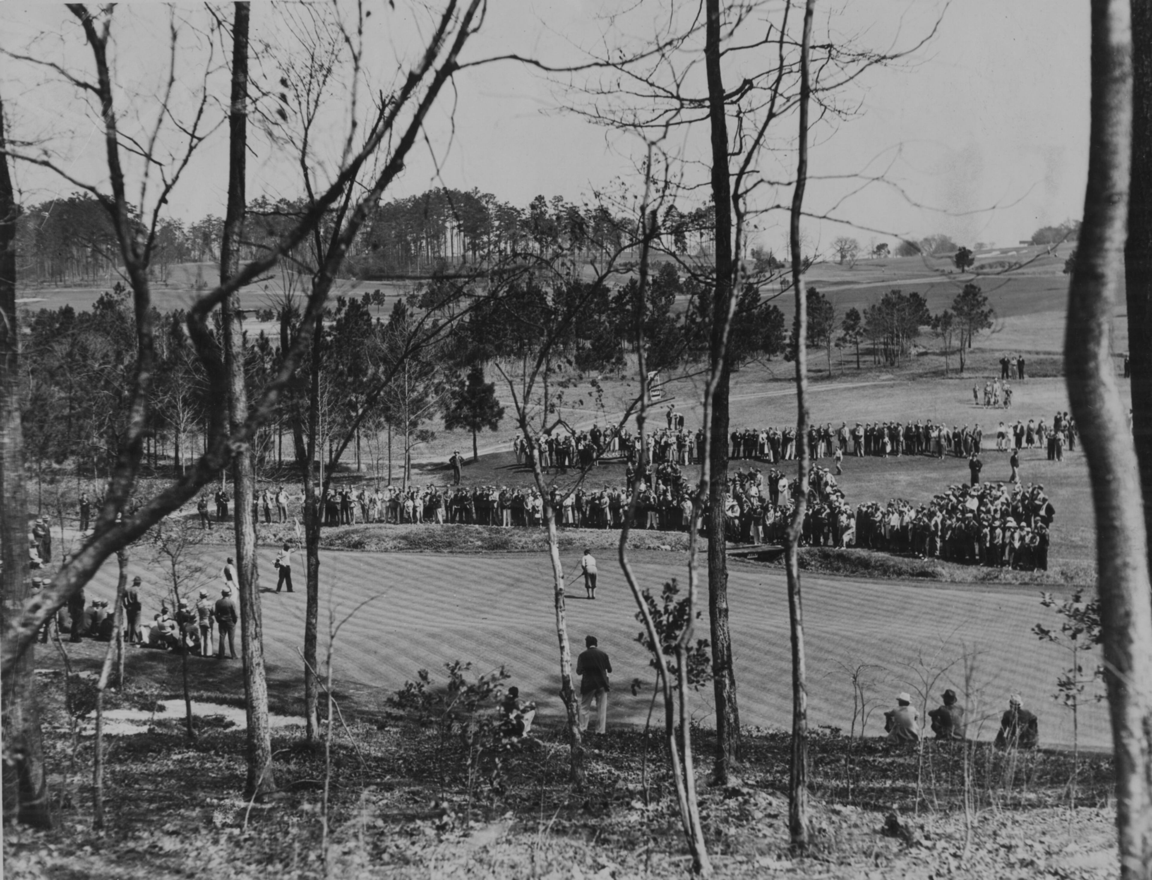 Original caption: "1930s -- Bobby Jones putting on the 13th green of the famous Augusta, Ga., course, where he will compete in the open golf tournament to be held April 2 to 5. The field will include the world's greatest players."