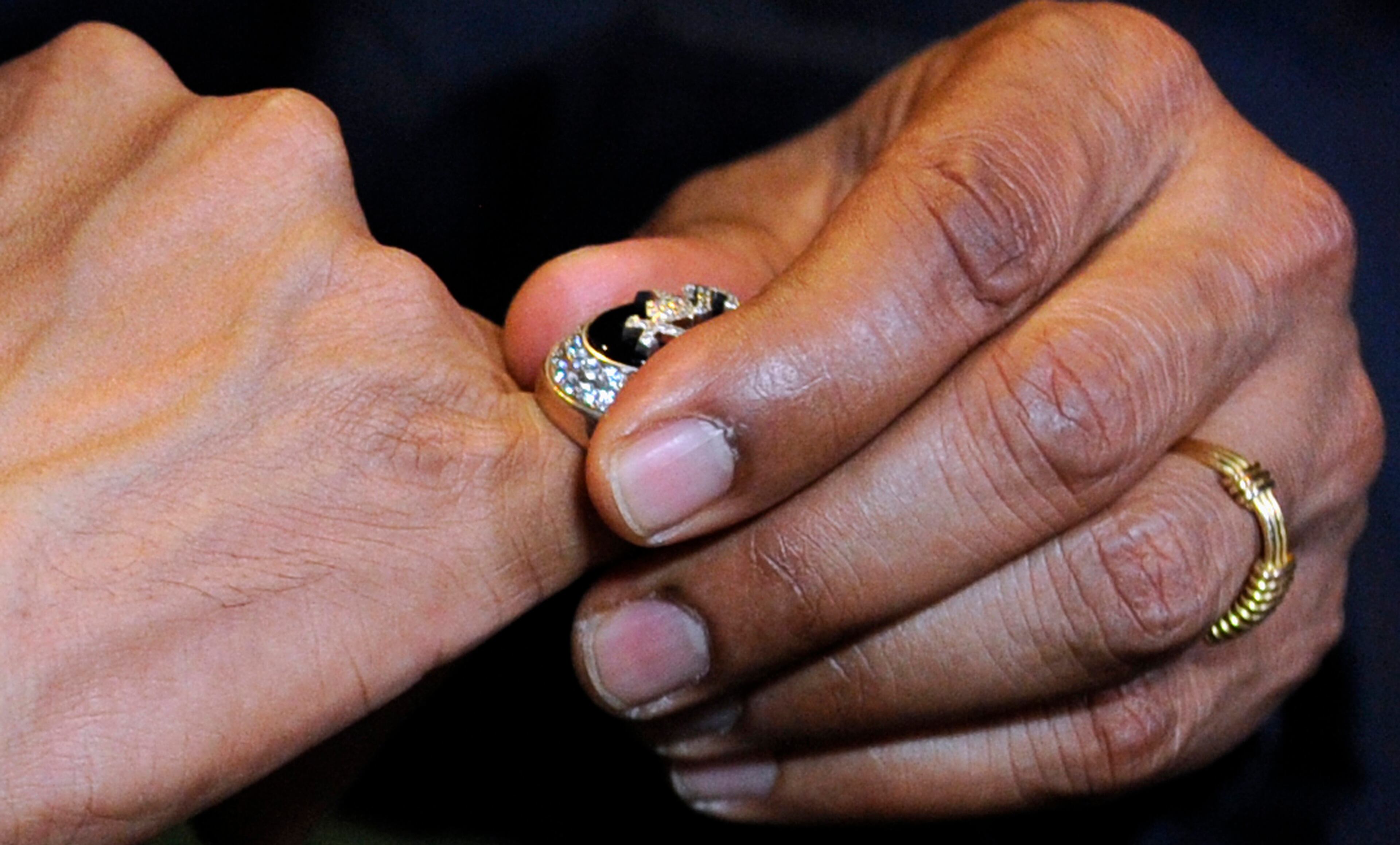 President Barack Obama tries on a 2005 Chicago White Sox World Series ring during a tour the Baseball Hall of Fame in Cooperstown, N.Y., Thursday, May 22, 2014. Obama visited the museum to highlight tourism and steps to help spur international visits to the 50 states. Obama said the overall U.S. economy and local businesses will benefit if it isn't a hassle for people from other countries to visit the U.S. and spend money at its hotels, restaurants, tourist destinations and other businesses. (AP Photo/Susan Walsh)