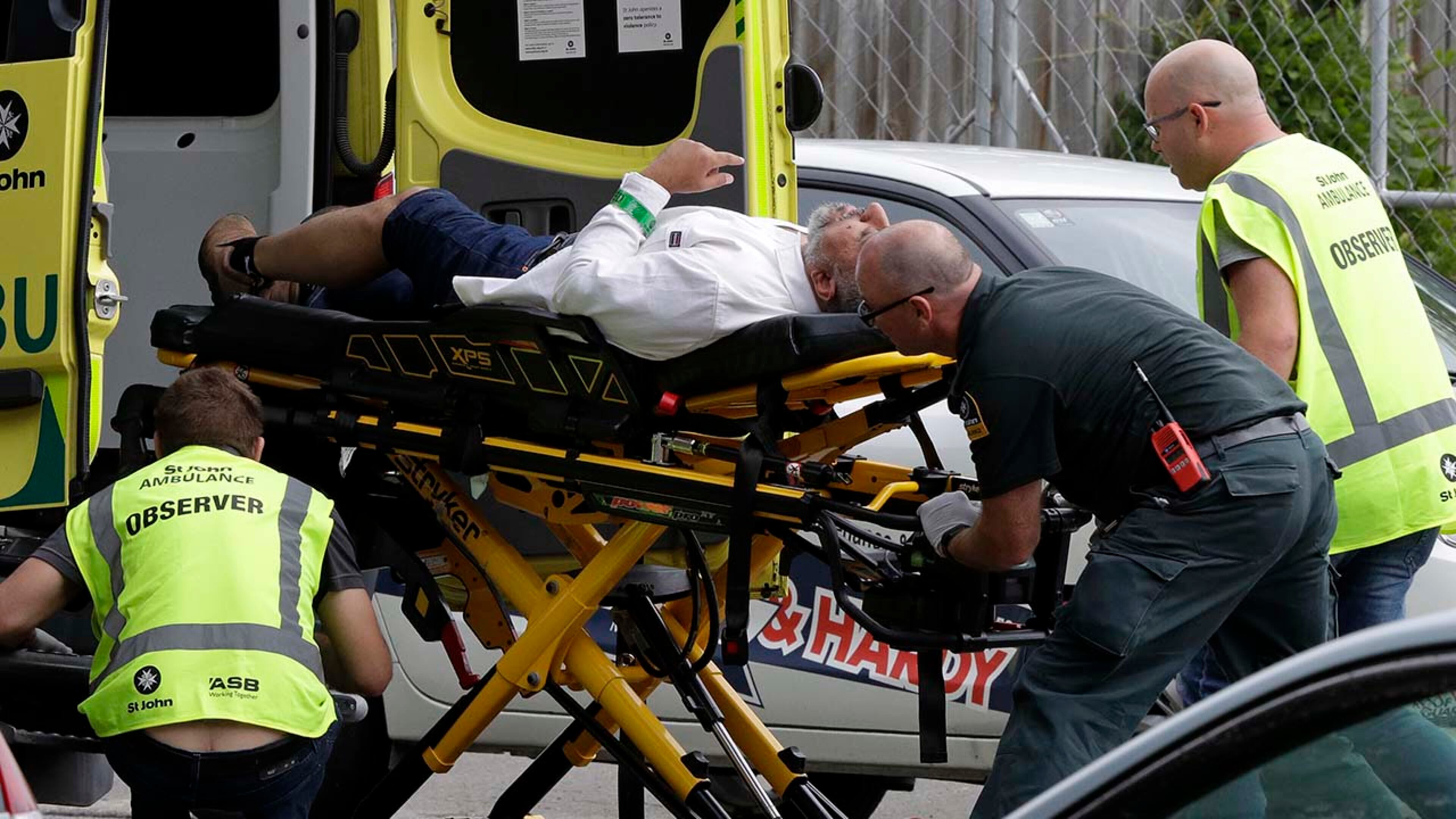 Ambulance staff take a man from outside a mosque in central Christchurch, New Zealand, Friday, March 15, 2019. A witness says many people have been killed in a mass shooting at a mosque in the New Zealand city of Christchurch.