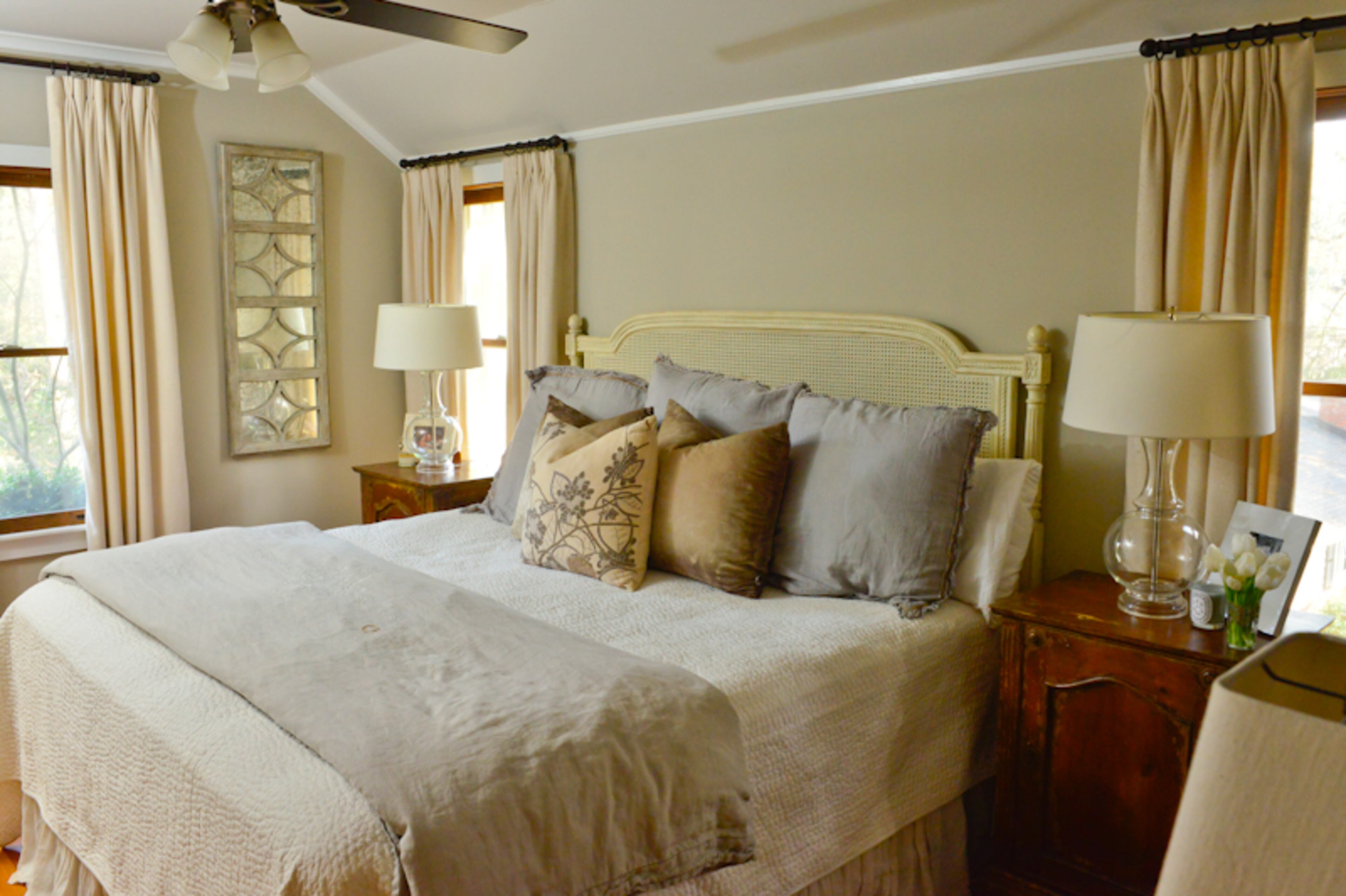 Erin and Patrick Connolly have fitted their upstairs master bedroom with a bed by Ballard Designs and bedding by Pom Pom and Pine Cone Hill. The room is painted in Benjamin Moore's Revere Pewter.