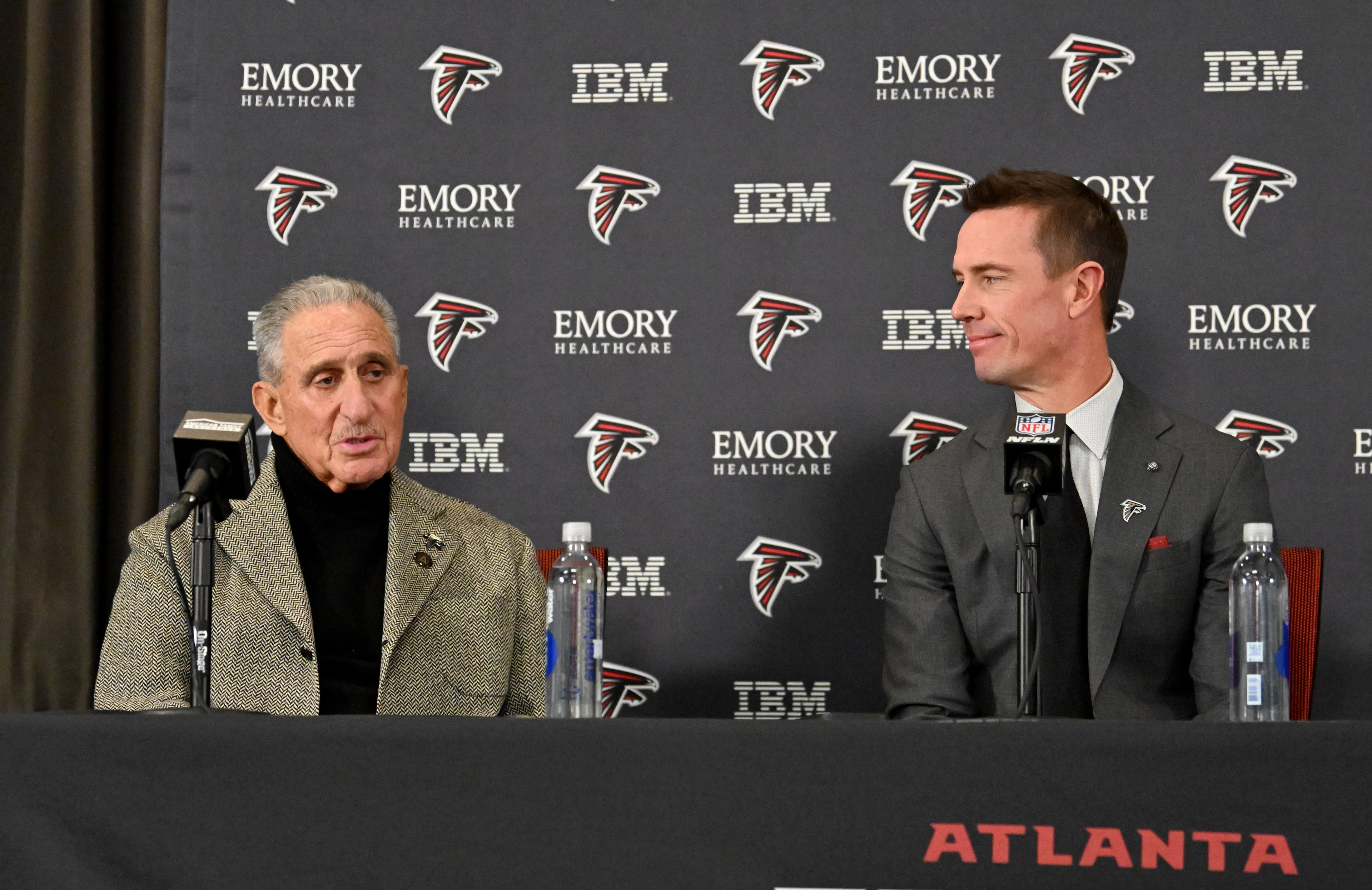 Atlanta Falcons owner Arthur Blank speaks as new Atlanta Falcons president of football Matt Ryan looks on during a news conference to introduce new Falcons president of football Matt Ryan, Tuesday, Jan. 13, 2026, in Flowery Branch. (Hyosub Shin/AJC)