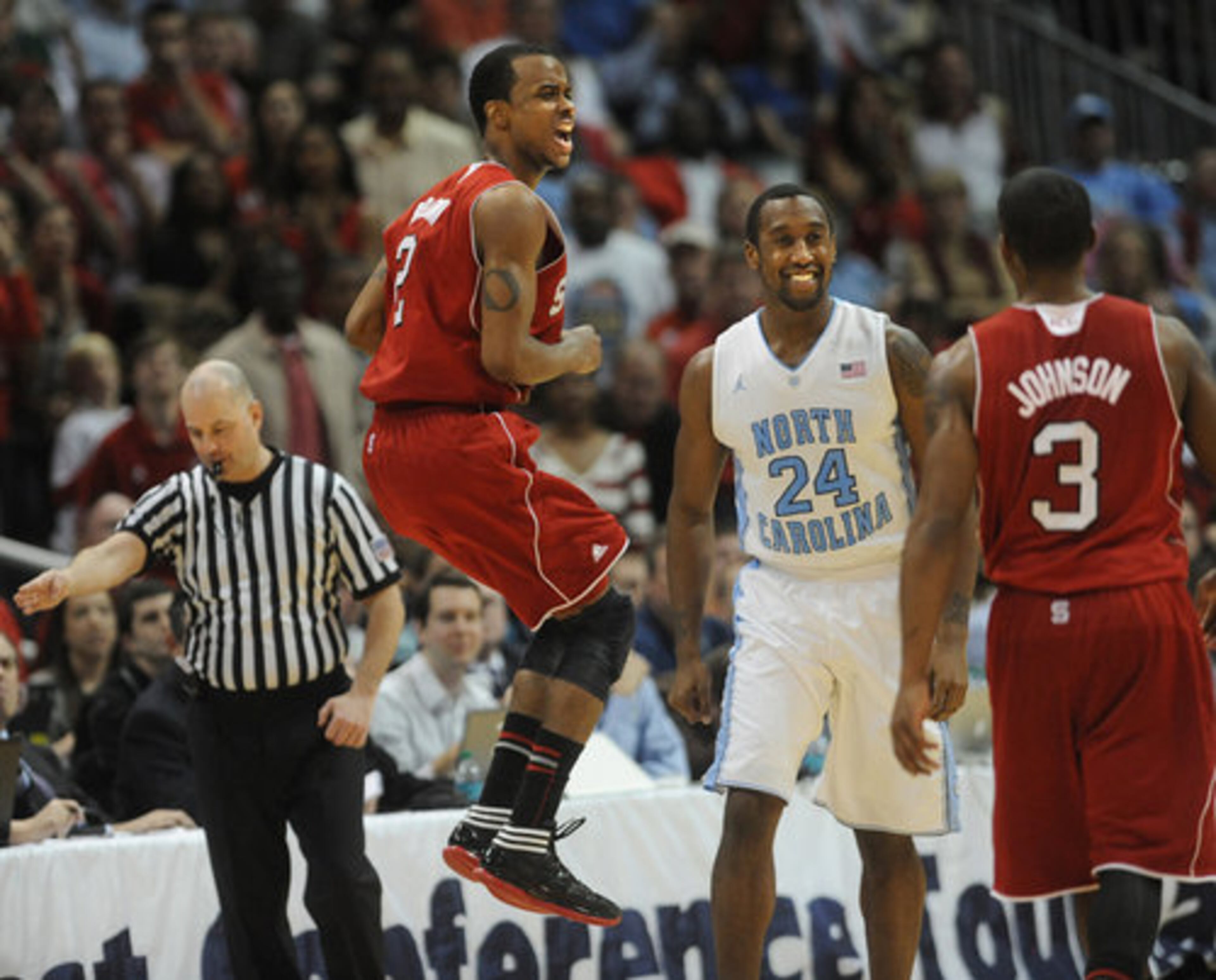 NC State's Lorenzo Brown jumps in frustration after missing a pass from teammate Alex Johnson (3) with less than a minute to go in the game. North Carolina's Justin Watts smiles as he goes to the sideline.