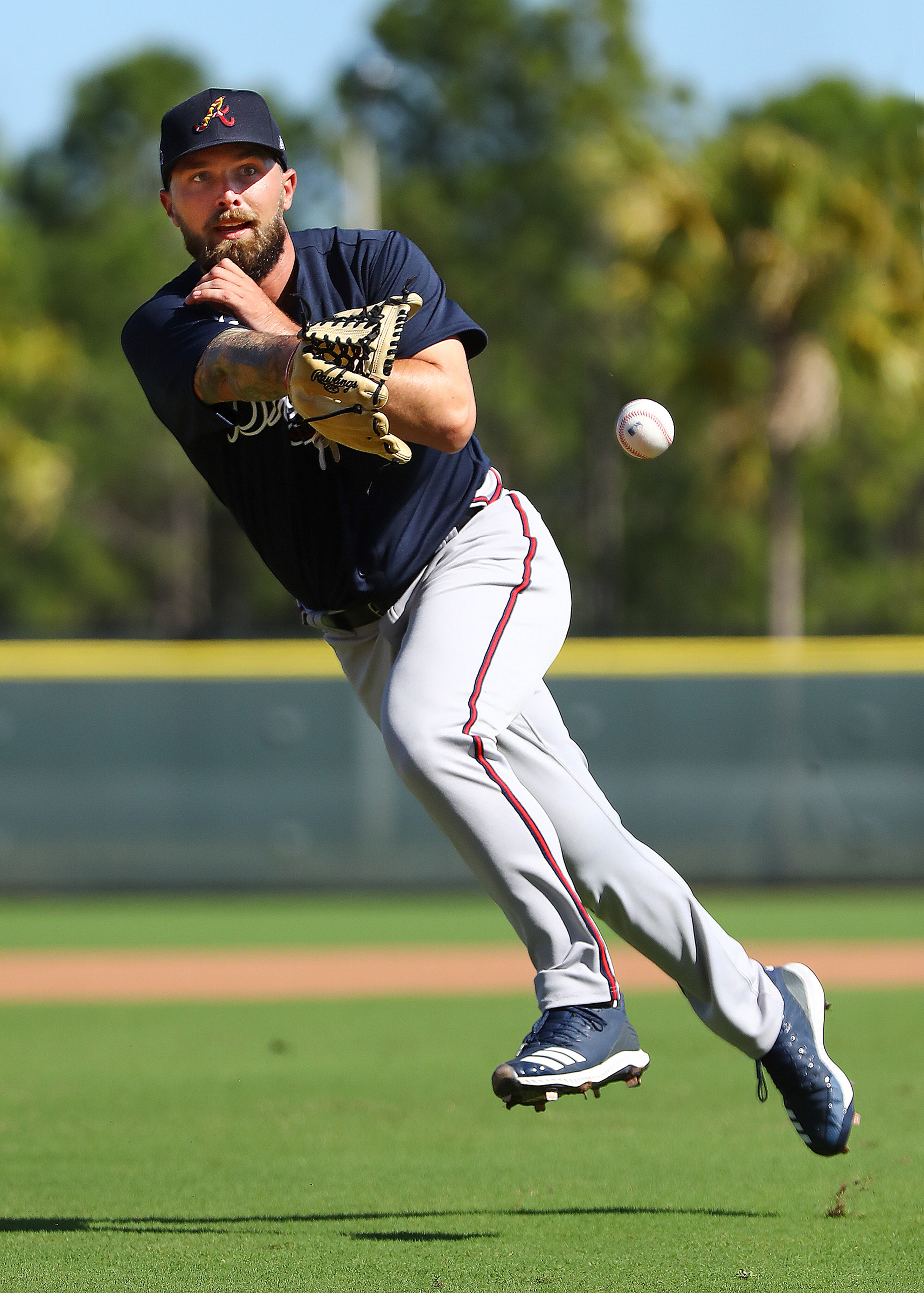 Braves pitcher Philip Pfeifer goes to home fielding a ground ball while running drills during spring training on Saturday, Feb. 15, 2020, in North Port. Curtis Compton ccompton@ajc.com